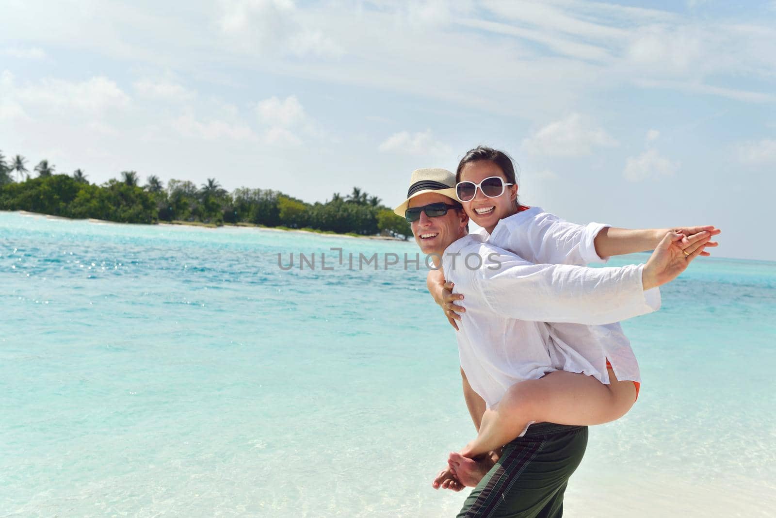 happy young romantic couple in love have fun running and relaxing on beautiful beach