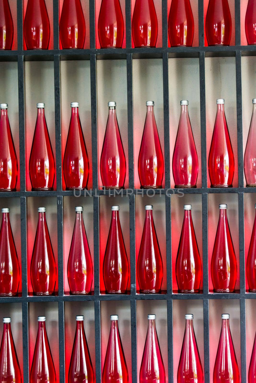 bottles of red juice in modern restaurant by dotshock