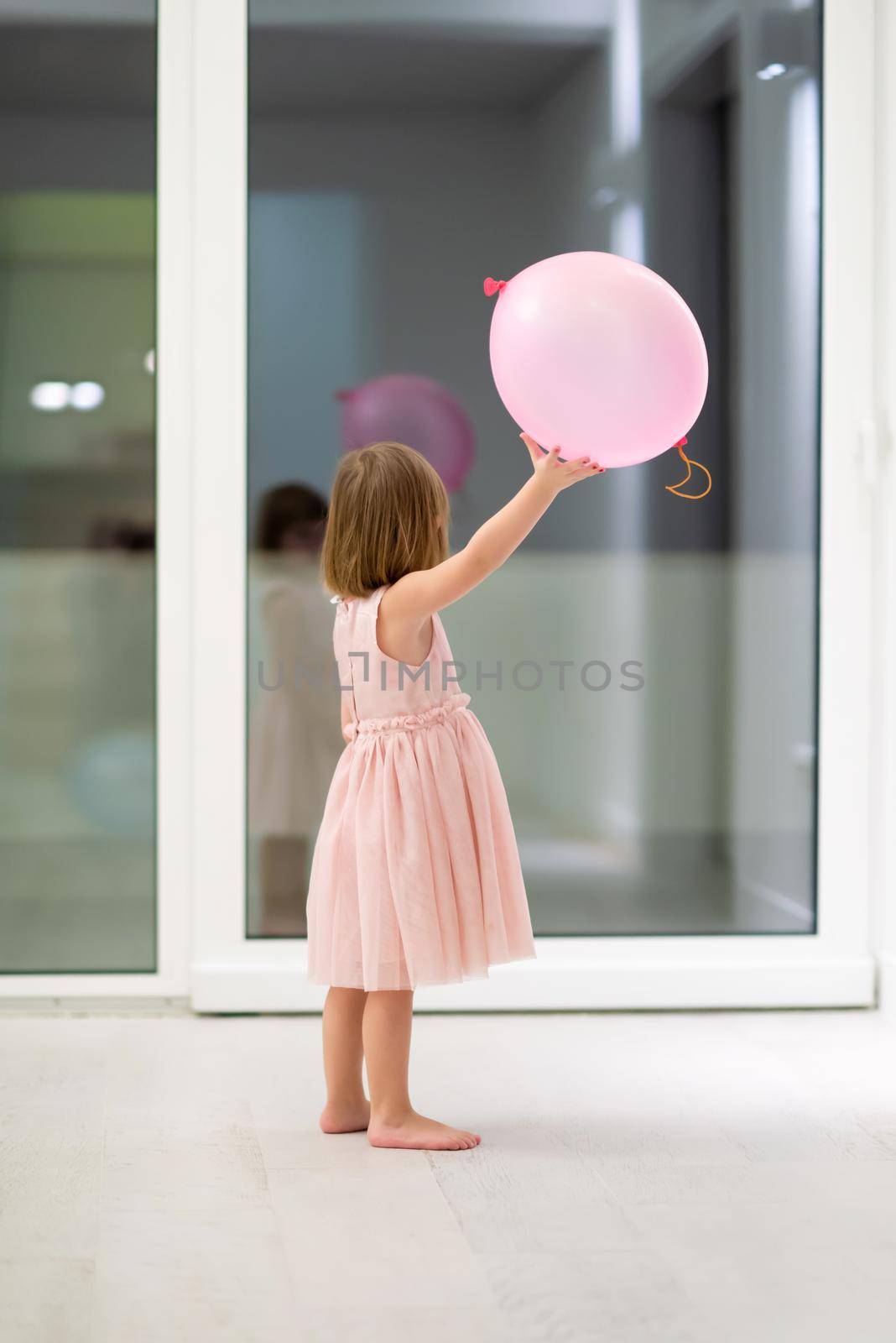 cute little girl playing with balloons by dotshock