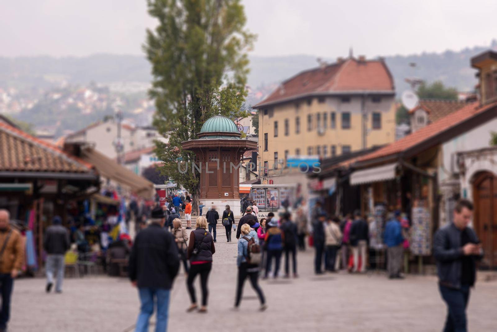 View of Bascarsija square with Sebilj wooden fountain,local businesses, locals and tourists in Old Town Sarajevo, capital city of Bosnia and Herzegovina.Sarajevo Bosnia and Herzegovina 26.09.2016