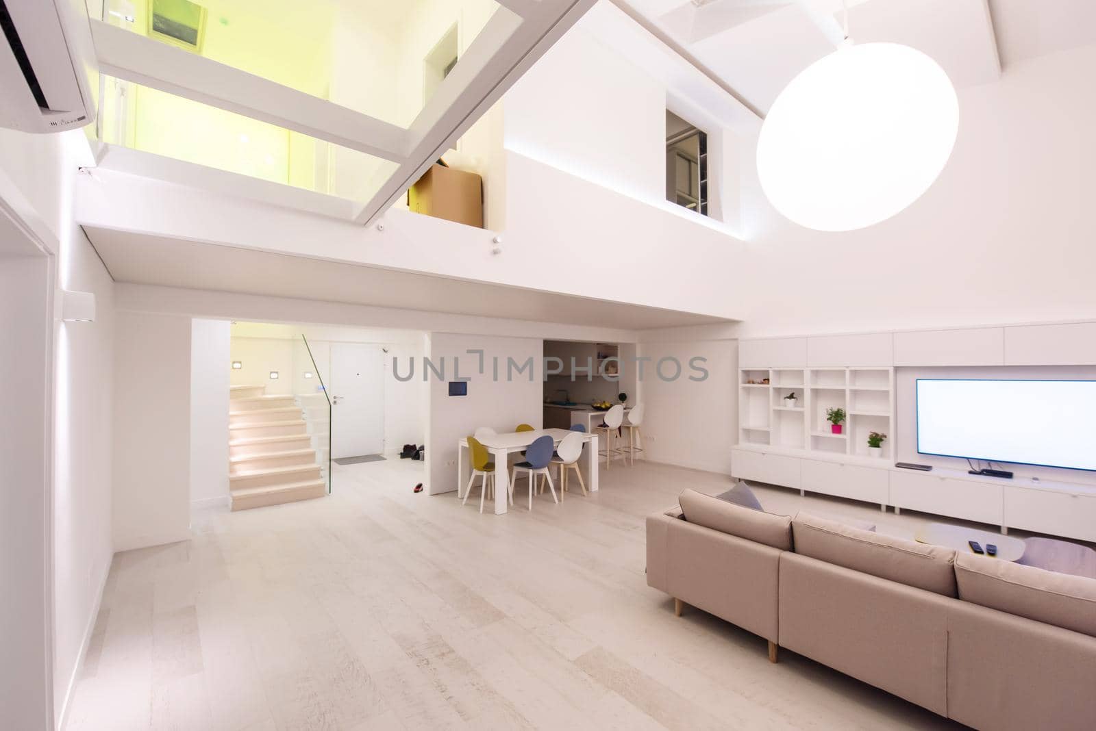 interior of a luxury stylish modern open space design two level apartment with white walls