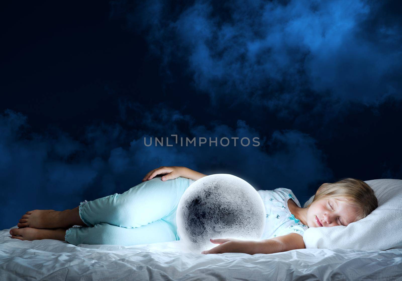 Cute girl sitting in bed and looking at moon planet