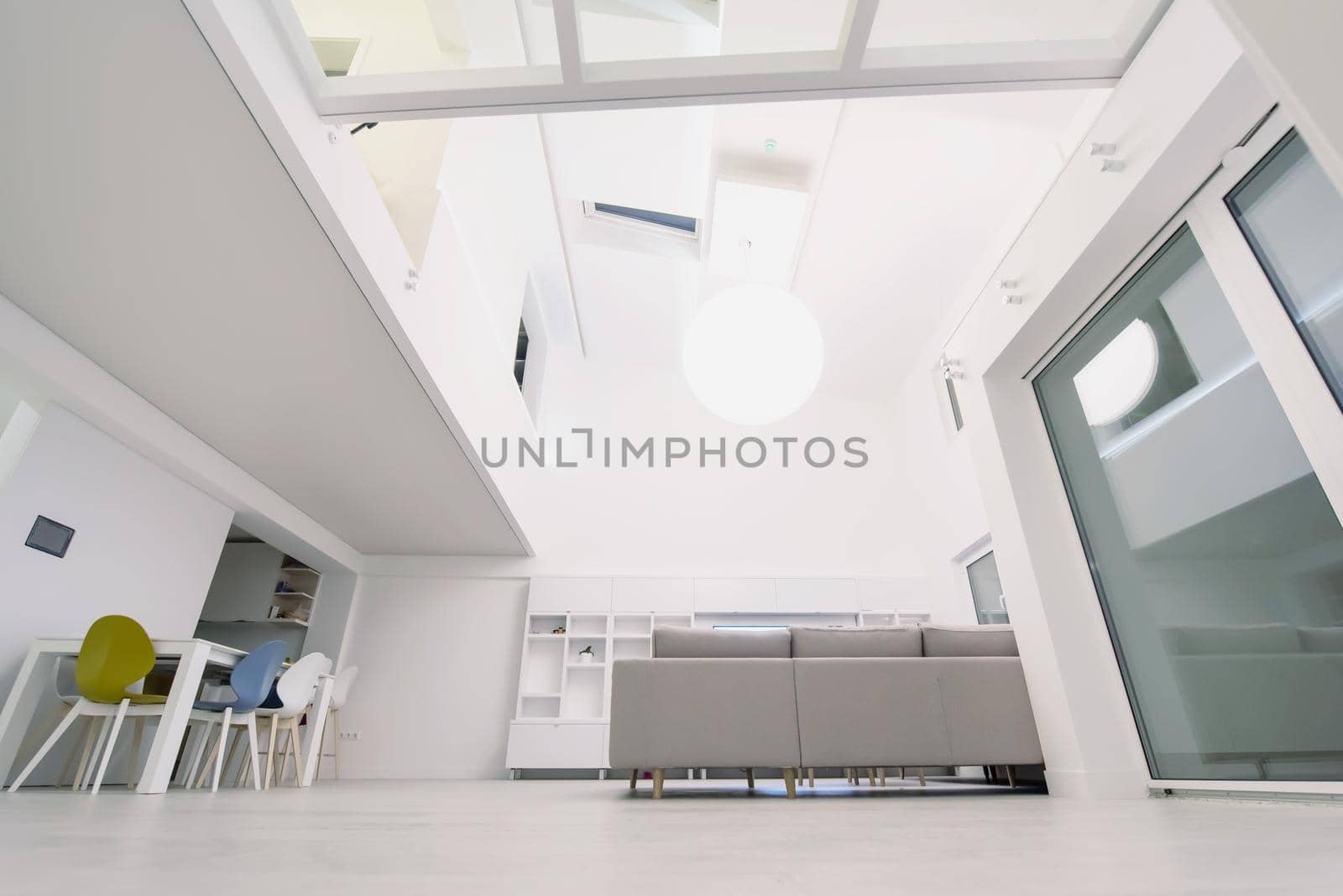 interior of a luxury stylish modern open space design two level apartment with white walls