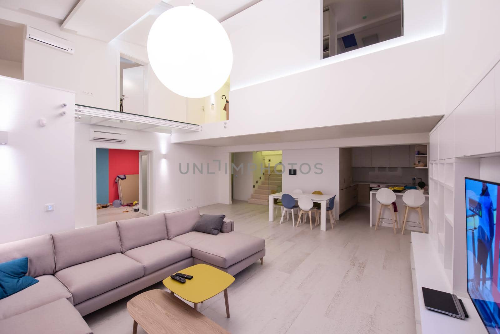 interior of a luxury stylish modern open space design two level apartment with white walls