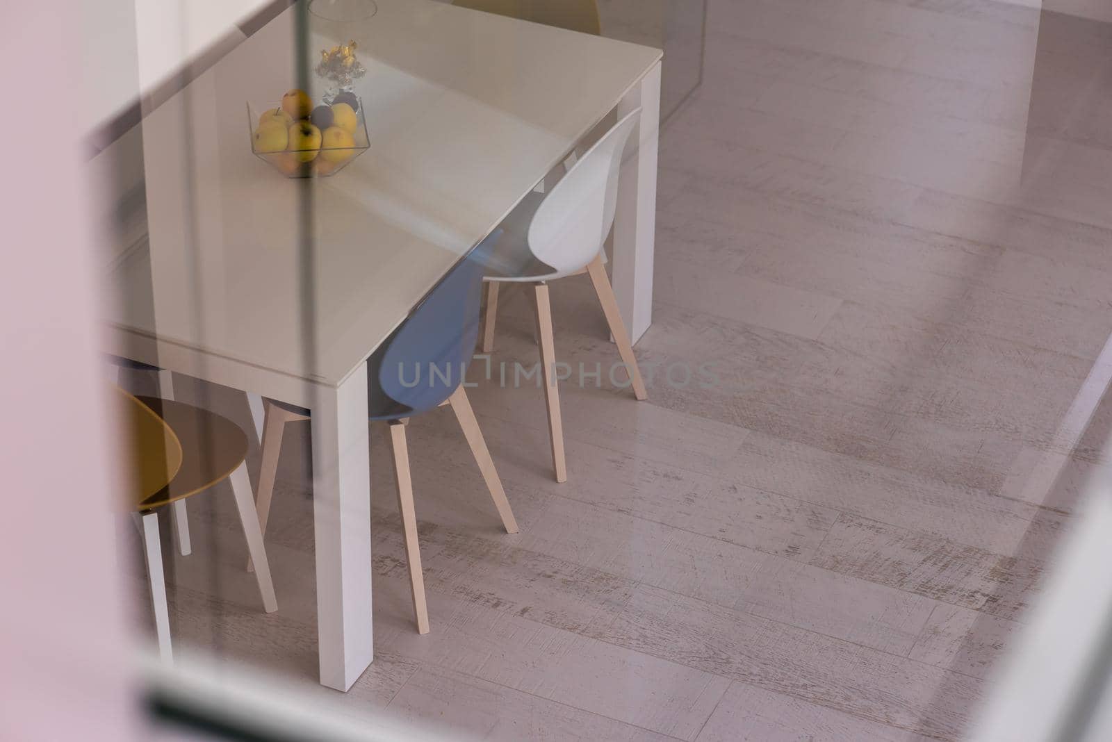 outside view trough window dining table in luxury interior of stylish modern open space two level apartment design