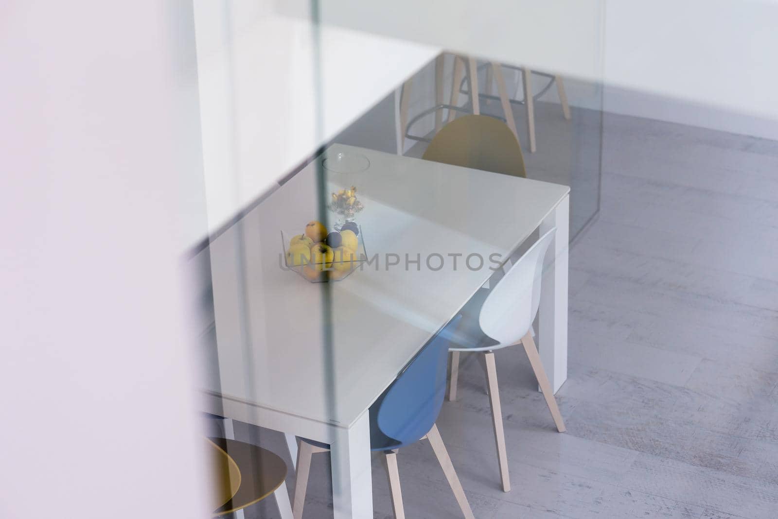 outside view trough window dining table in luxury interior of stylish modern open space two level apartment design
