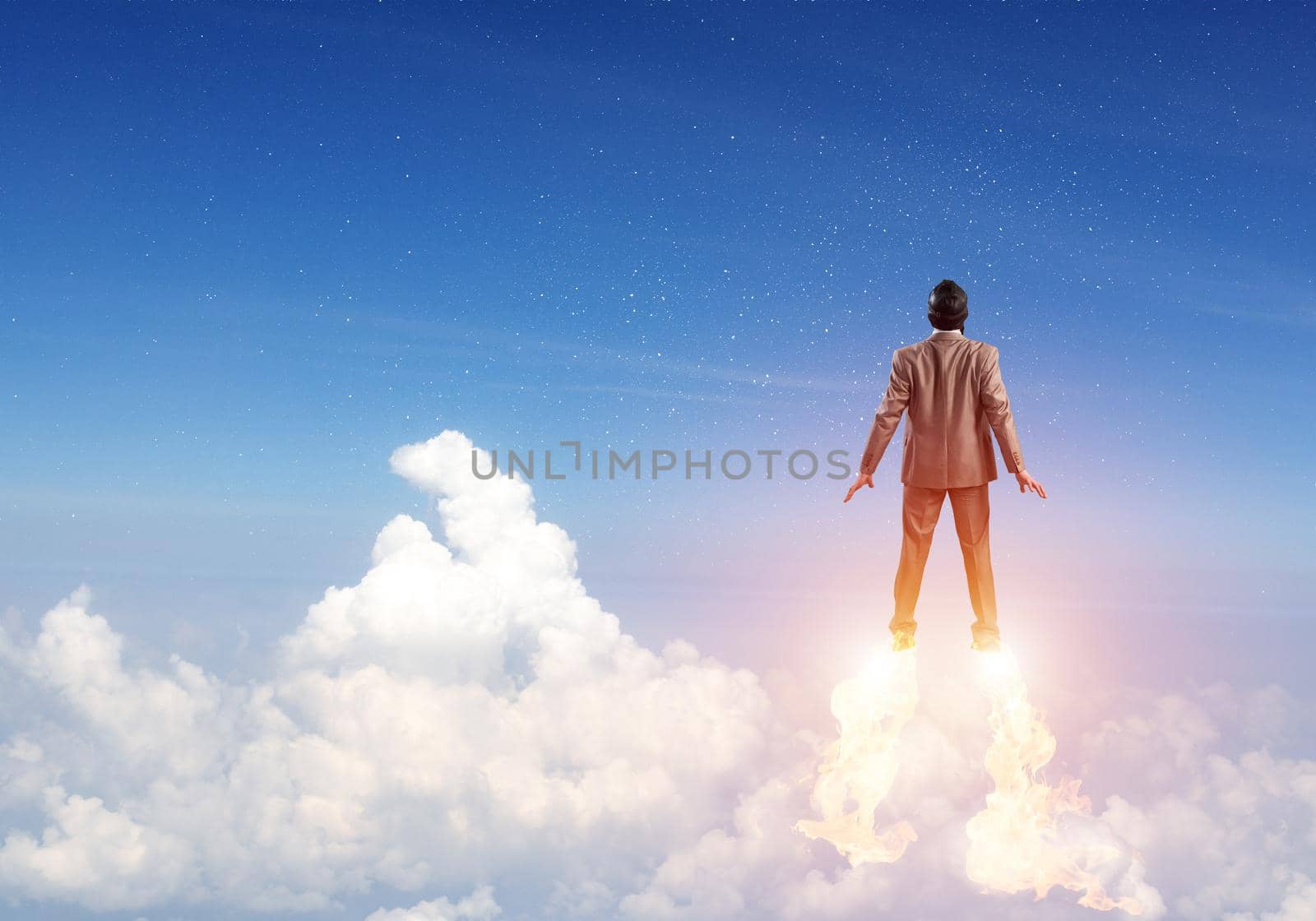 Businessman in suit and aviator hat flying in blue sky as superhero. Back view of corporate manager as superman launching upwards with jet flame to space. Successful business startup concept
