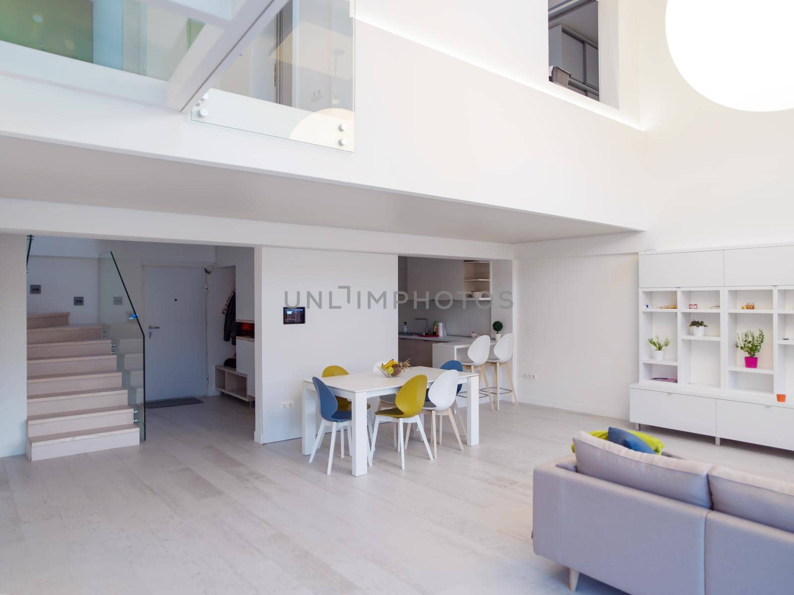 interior of a luxury stylish modern open space design two level apartment with white walls