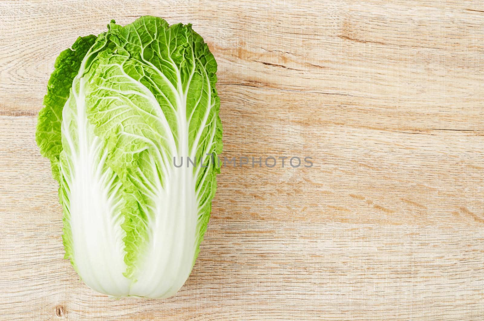 Fresh chinese cabbage on wooden background with copy space.