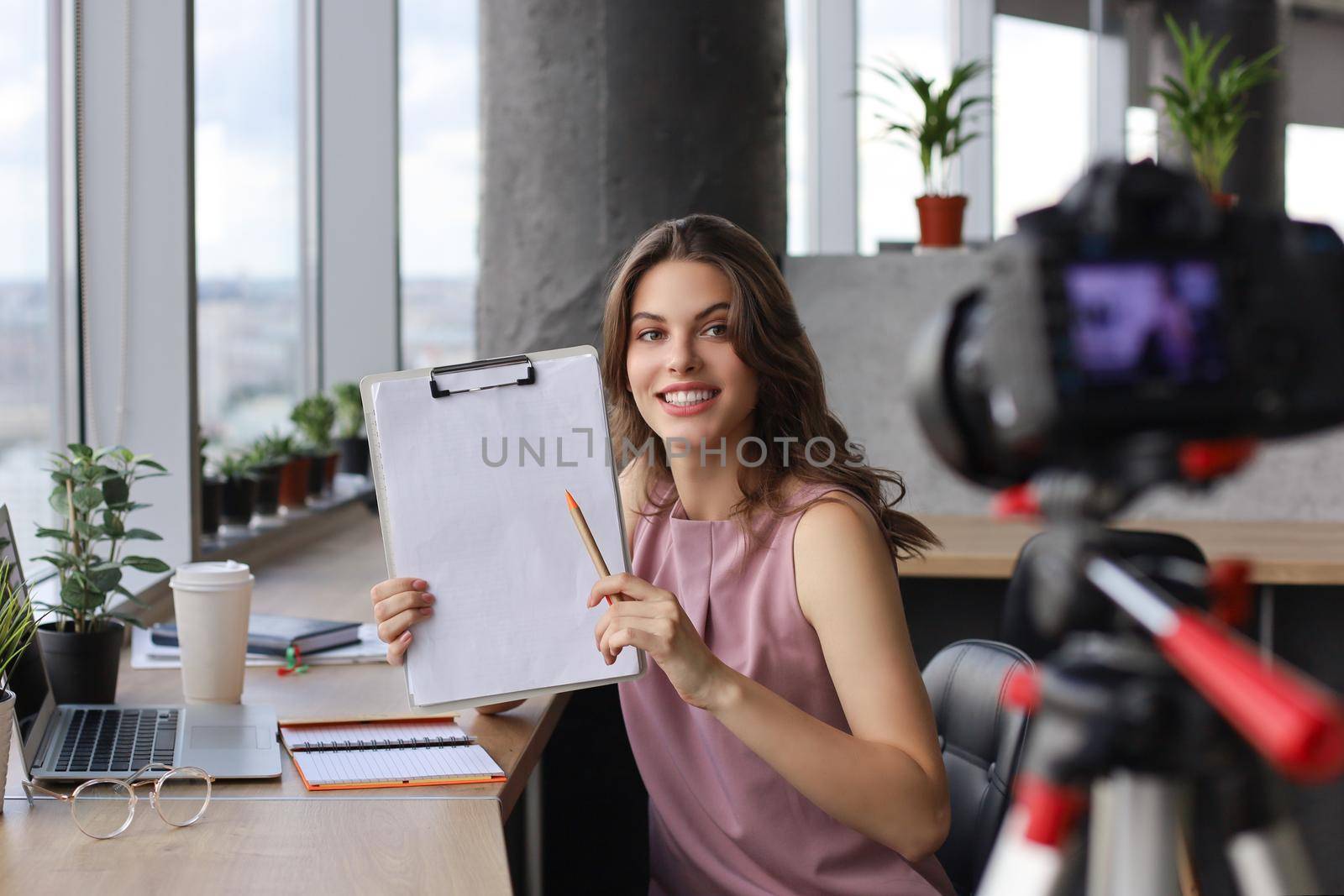 Beautiful young woman talking and smiling while making new video for her blog