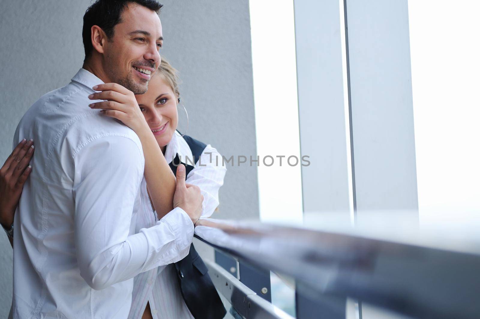 romantic happy couple relax and have fun at balcony in their new home apartment