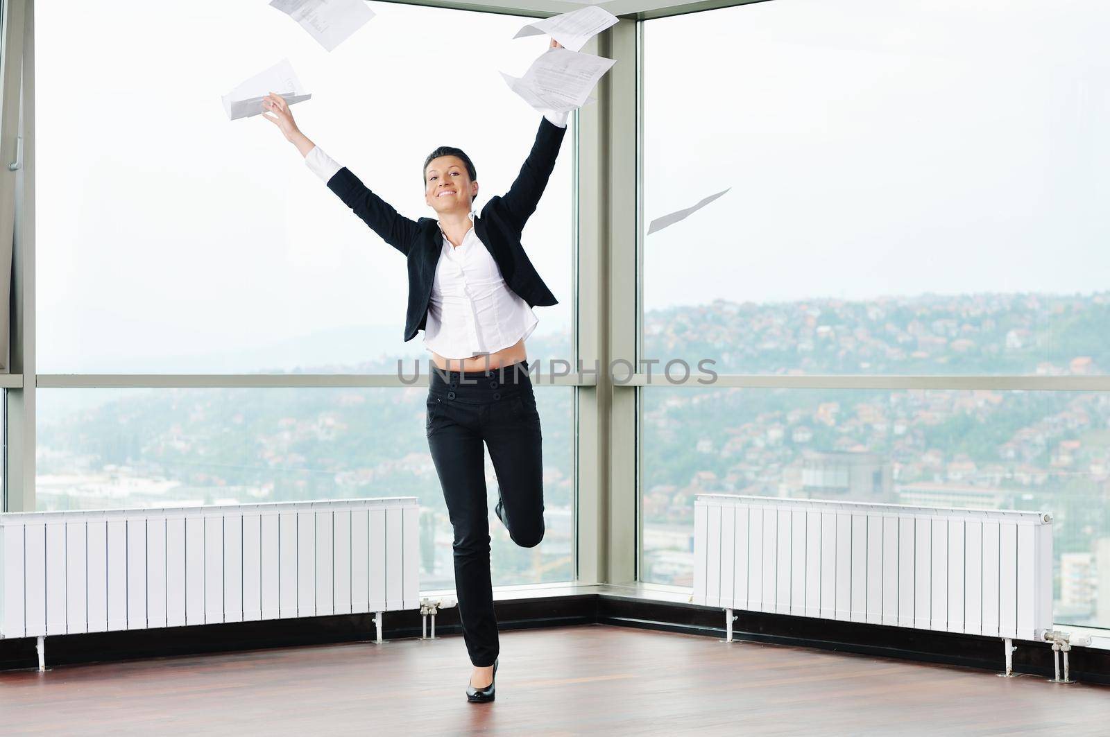 young business woman throw papers in air by dotshock
