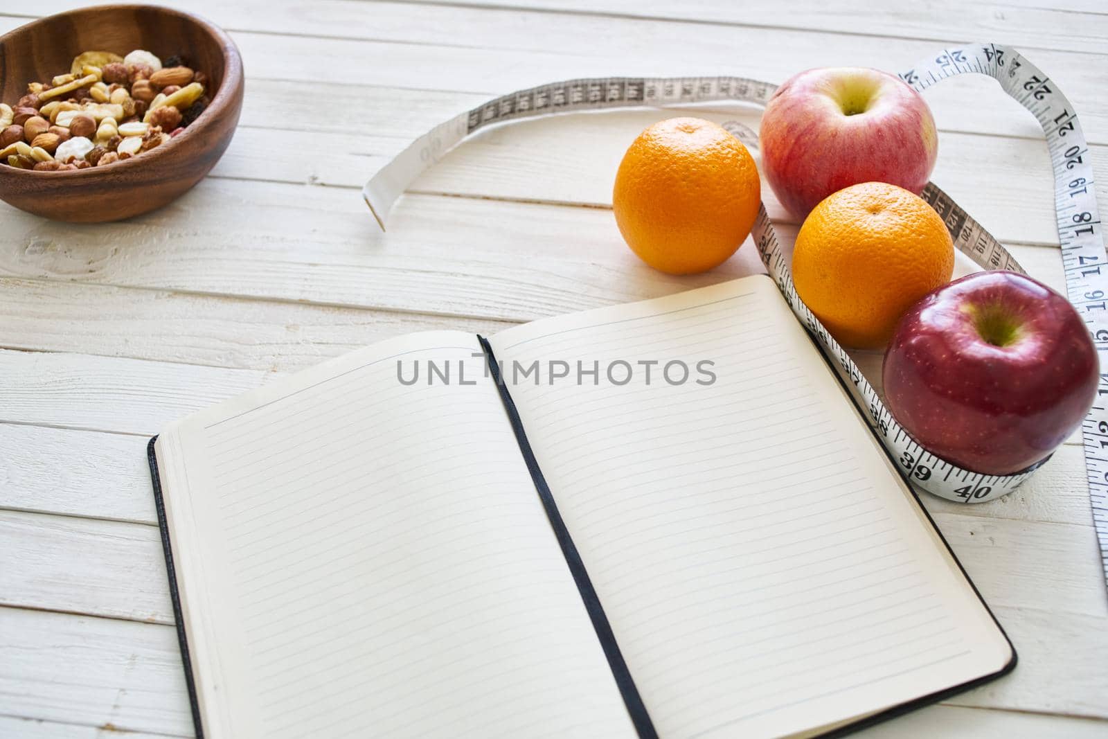 notepad on table measuring tape fruit breakfast nutritional fitness by Vichizh