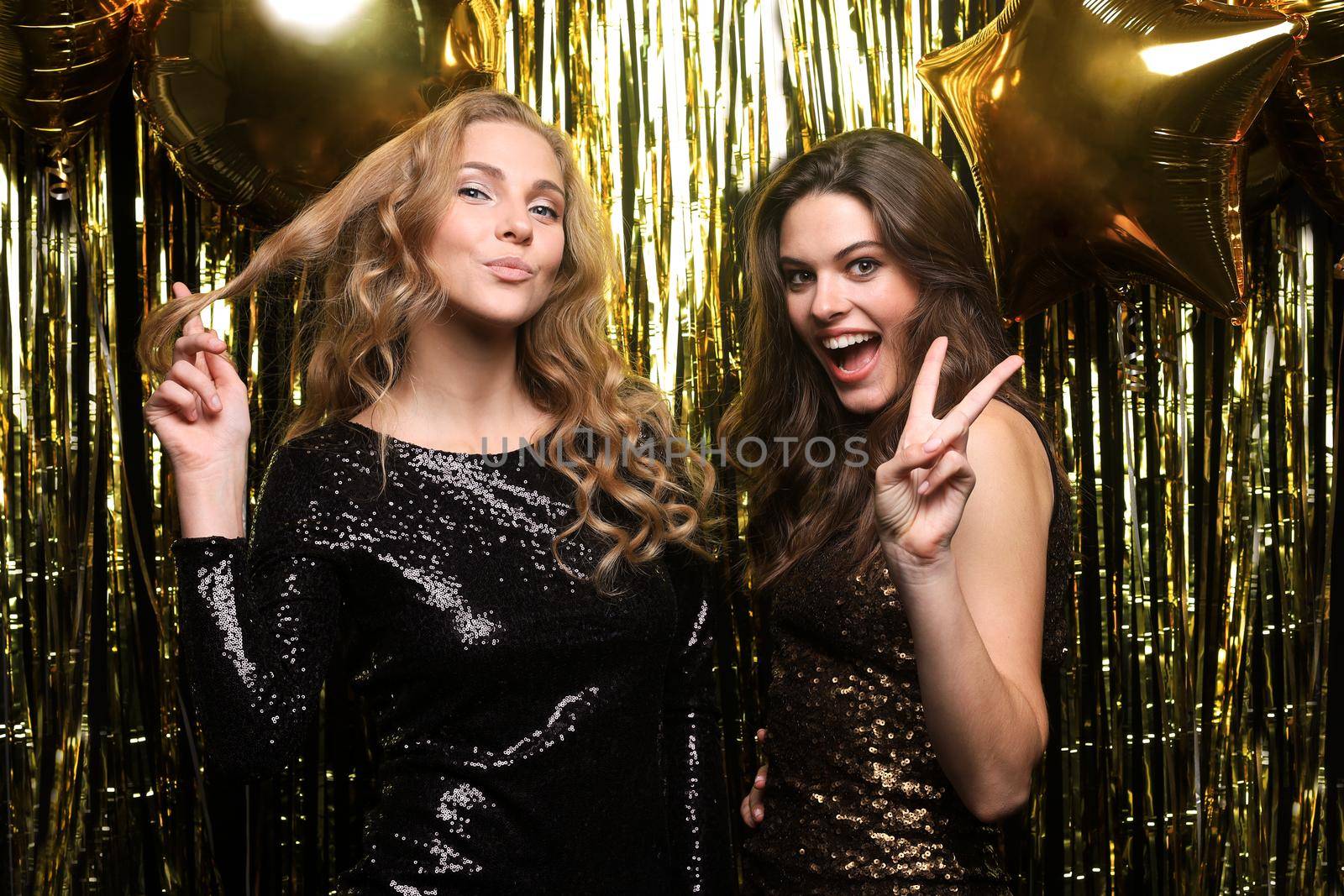 Beautiful girls celebrating New Year. Gorgeous smiling young women enjoying party celebration, having fun together