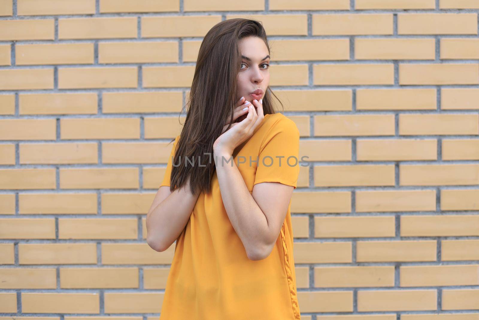 Beautiful smiling brunette model dressed in summer hipster clothes. Funny and positive woman having fun