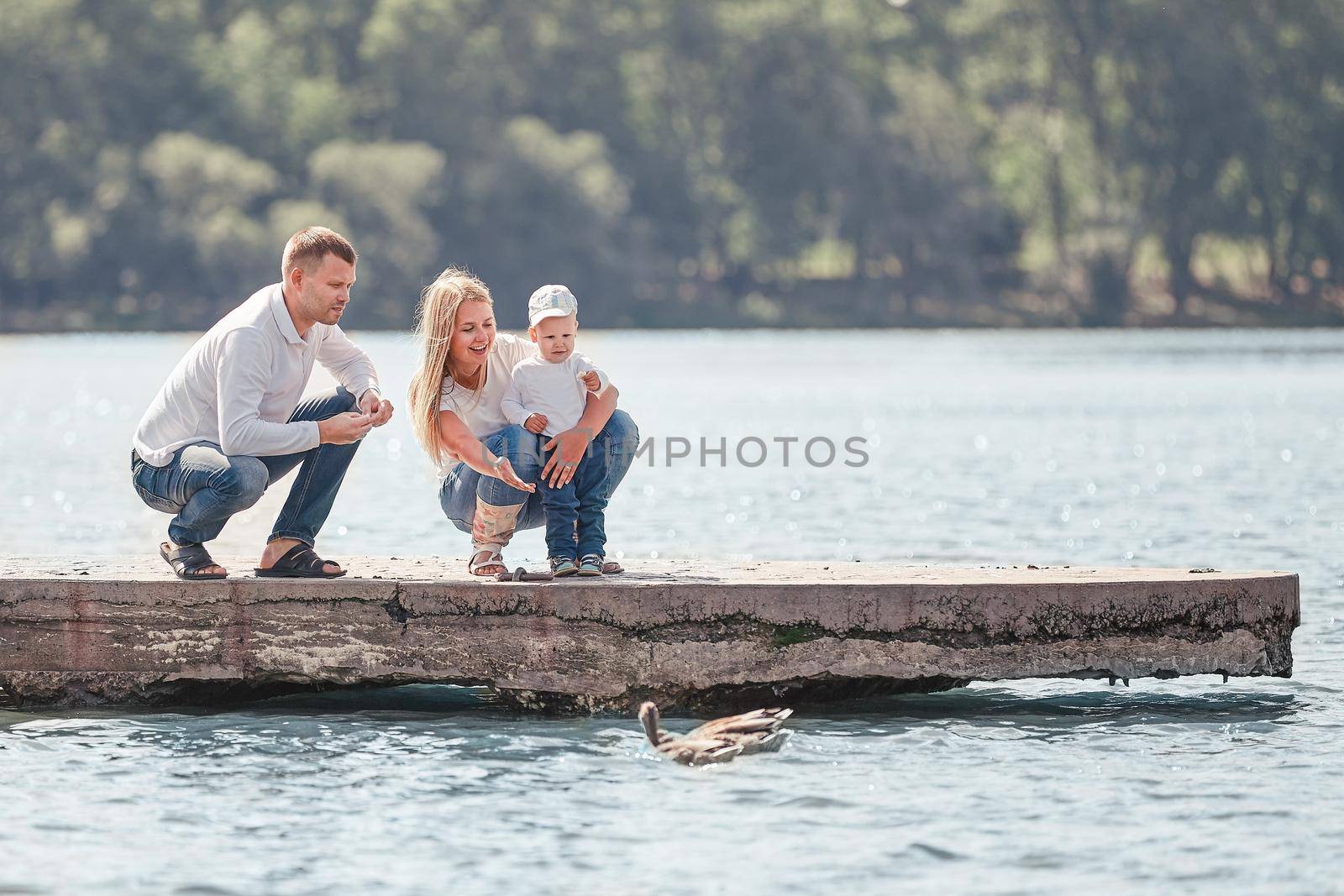 parents with their little son on a walk near the lake by SmartPhotoLab