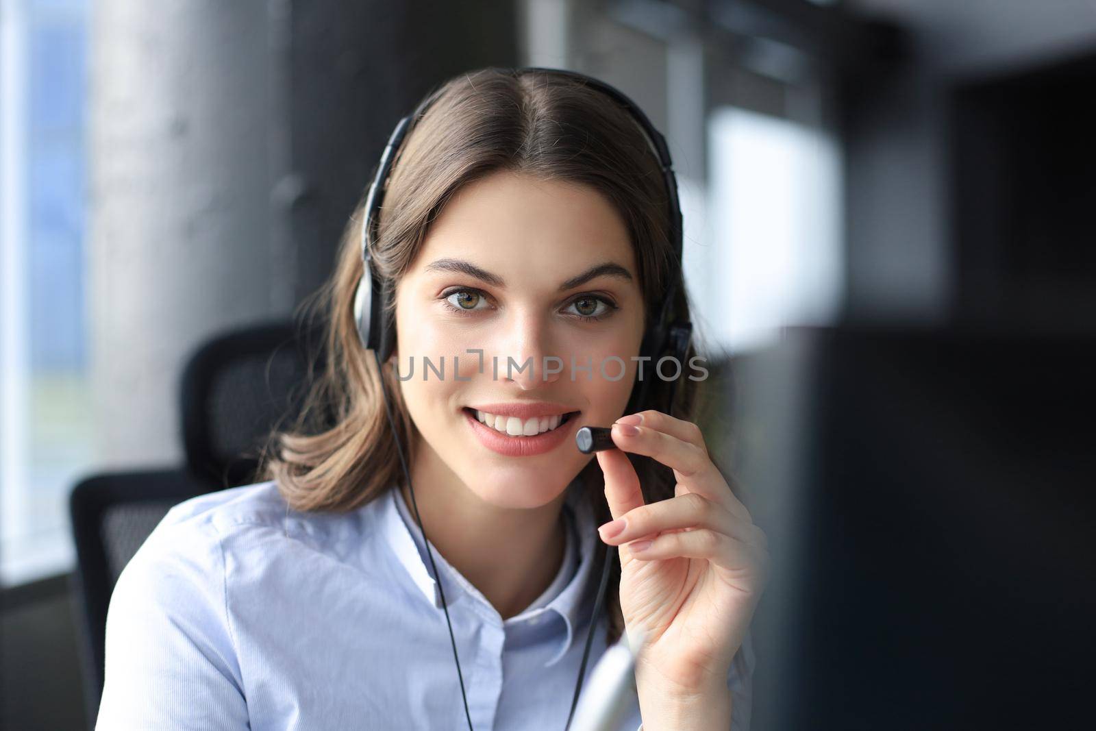 Female customer support operator with headset and smiling
