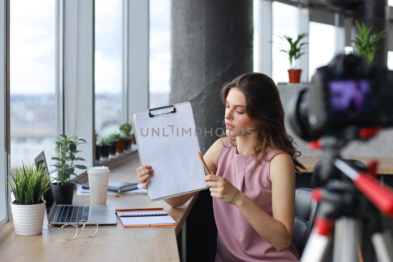 Beautiful young woman talking and smiling while making new video for her blog