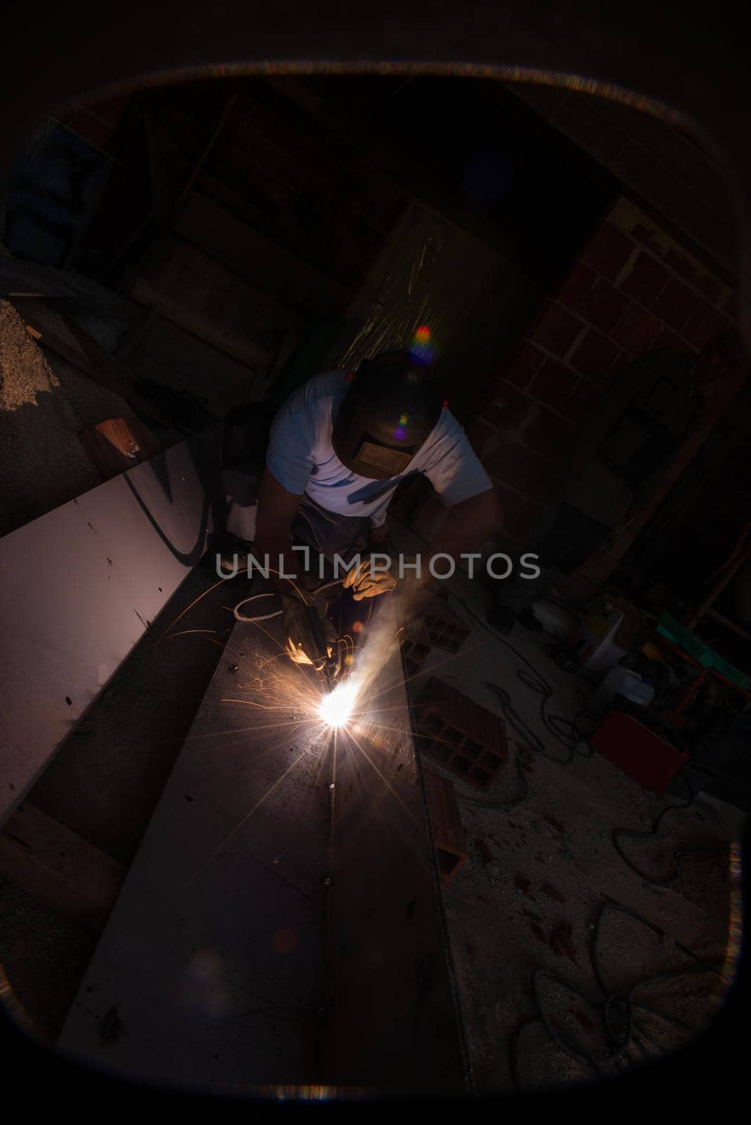 welder with protective mask welding steel by dotshock
