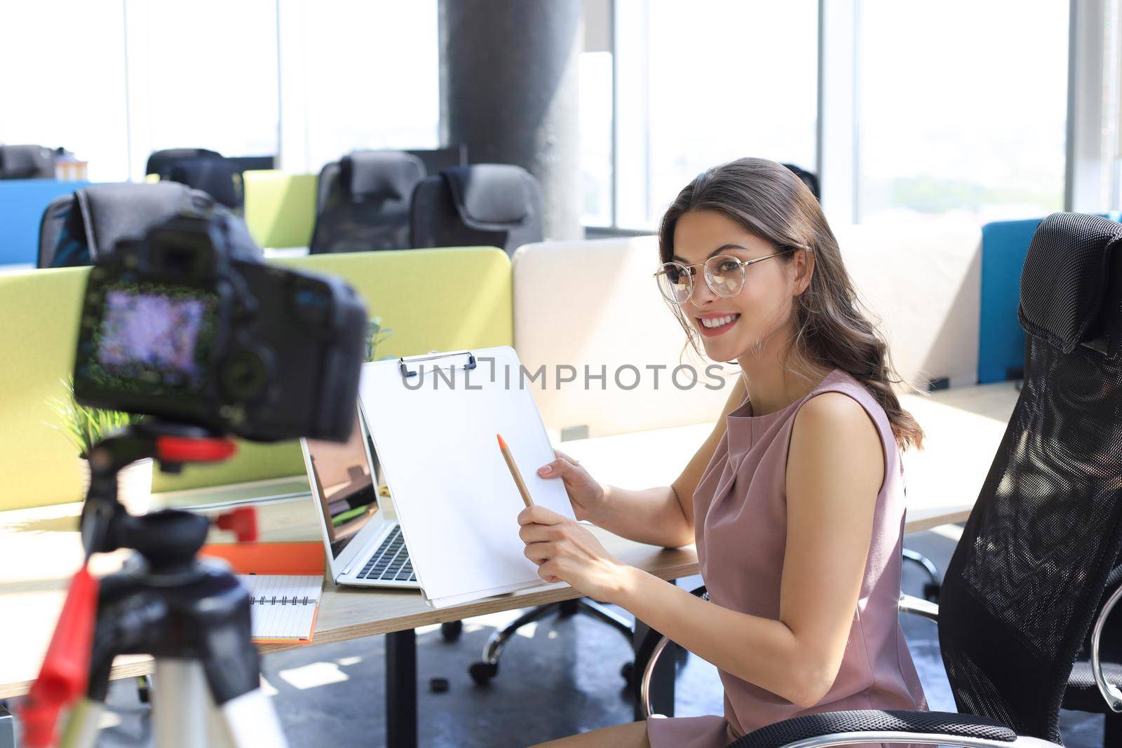 Beautiful young woman talking and smiling while making new video for her blog