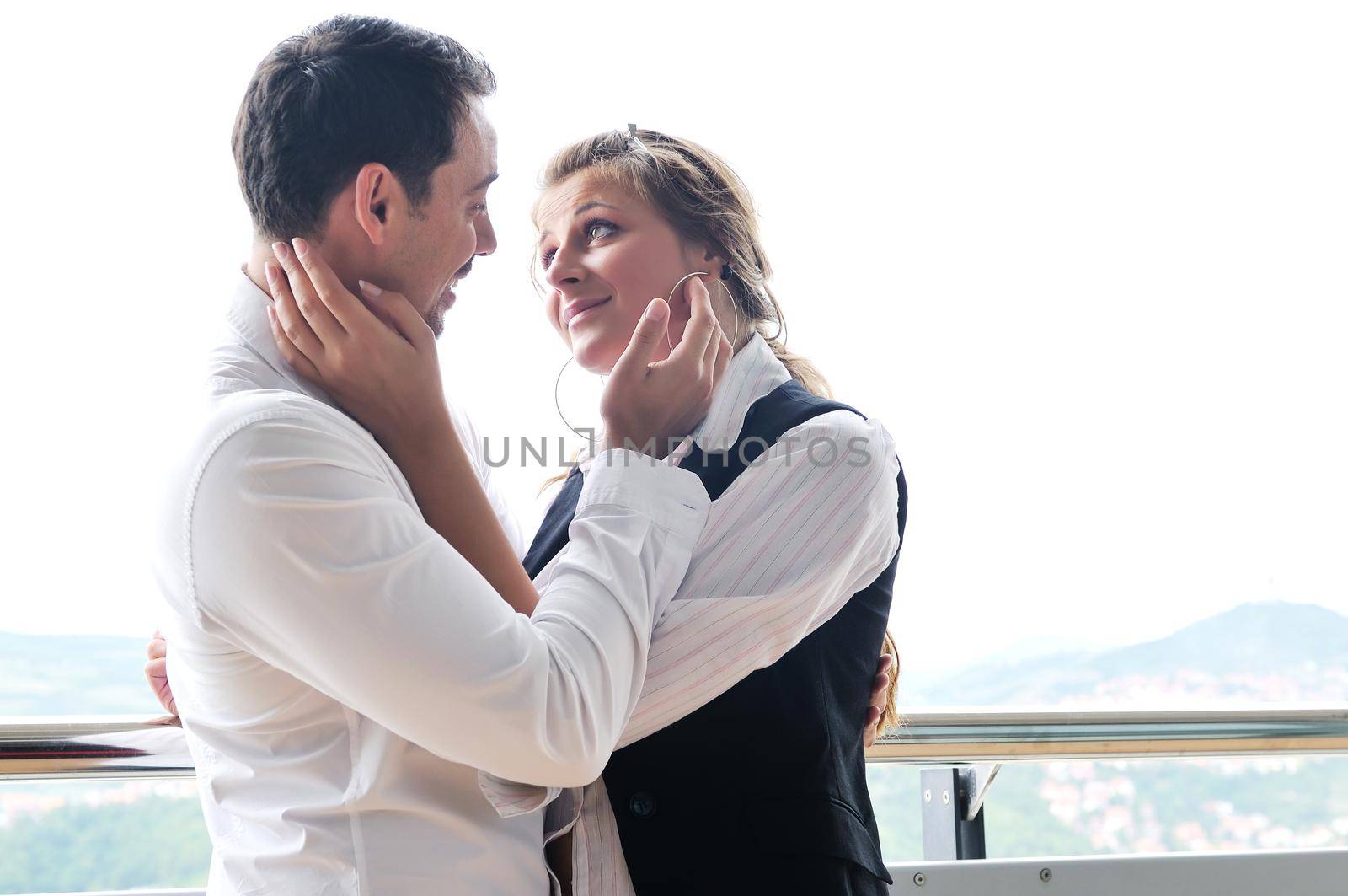 romantic happy couple relax and have fun at balcony in their new home apartment