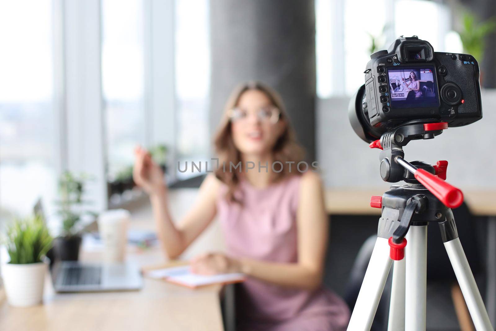 Beautiful young woman talking and smiling while making new video for her blog