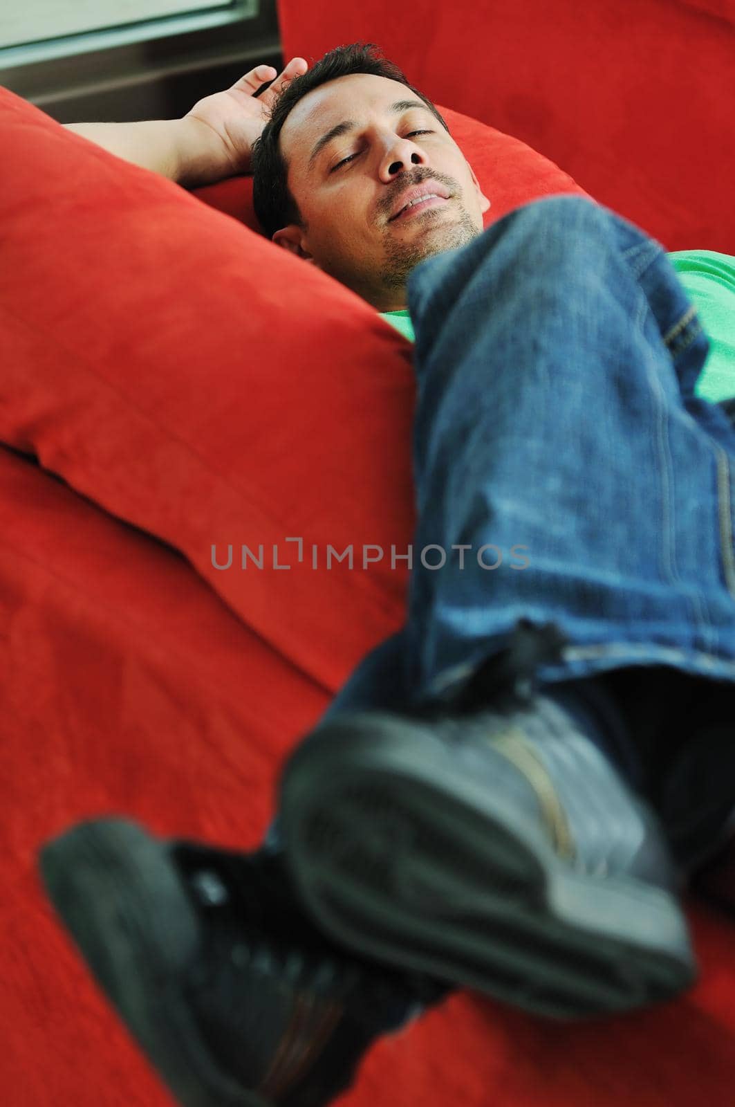 man relaxing on sofa  by dotshock