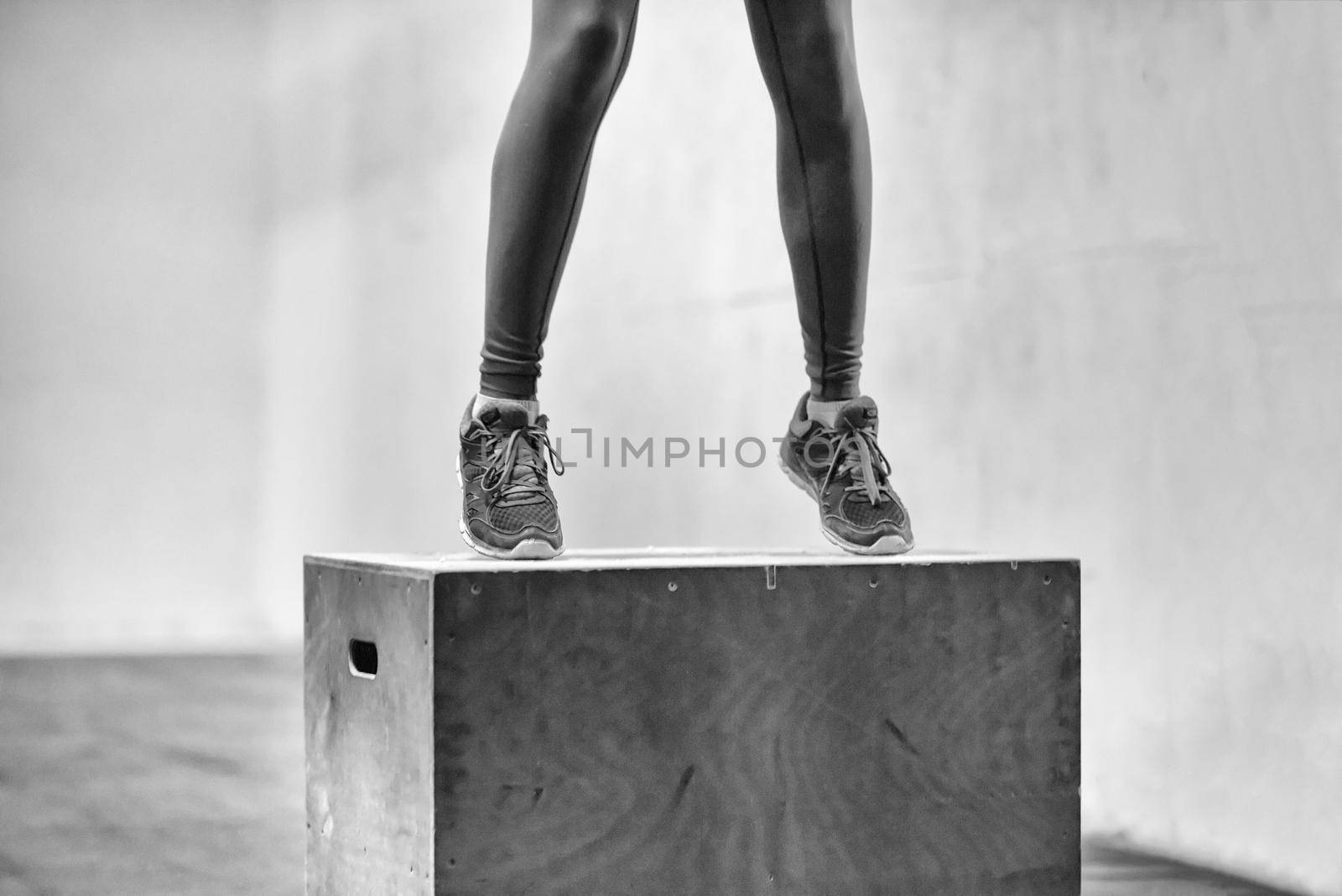 black woman is performing box jumps at gym by dotshock
