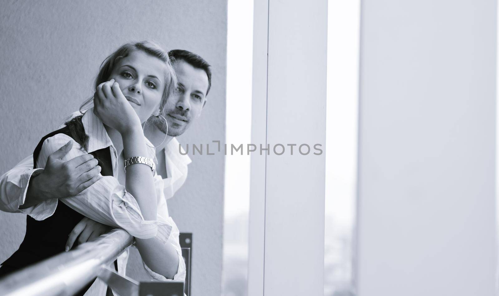 romantic happy couple relax and have fun at balcony in their new home apartment