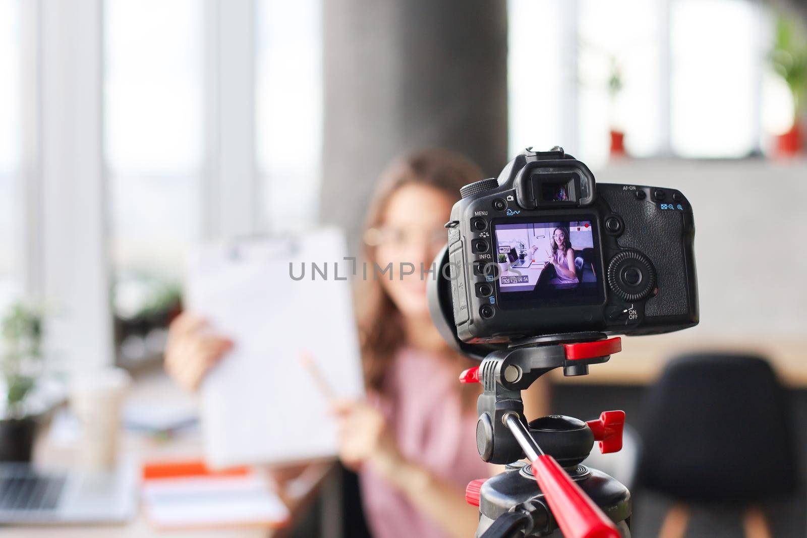 Beautiful young woman talking and smiling while making new video for her blog