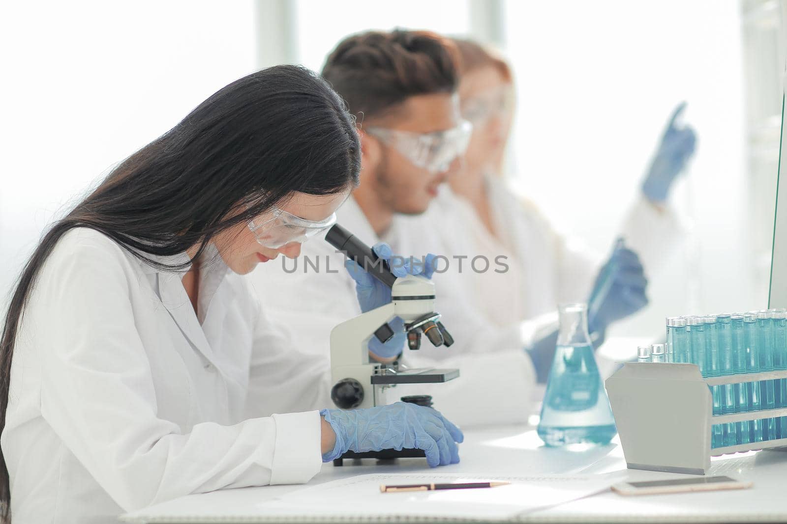 close up.scientists and laboratory workers sitting at the laboratory table by SmartPhotoLab