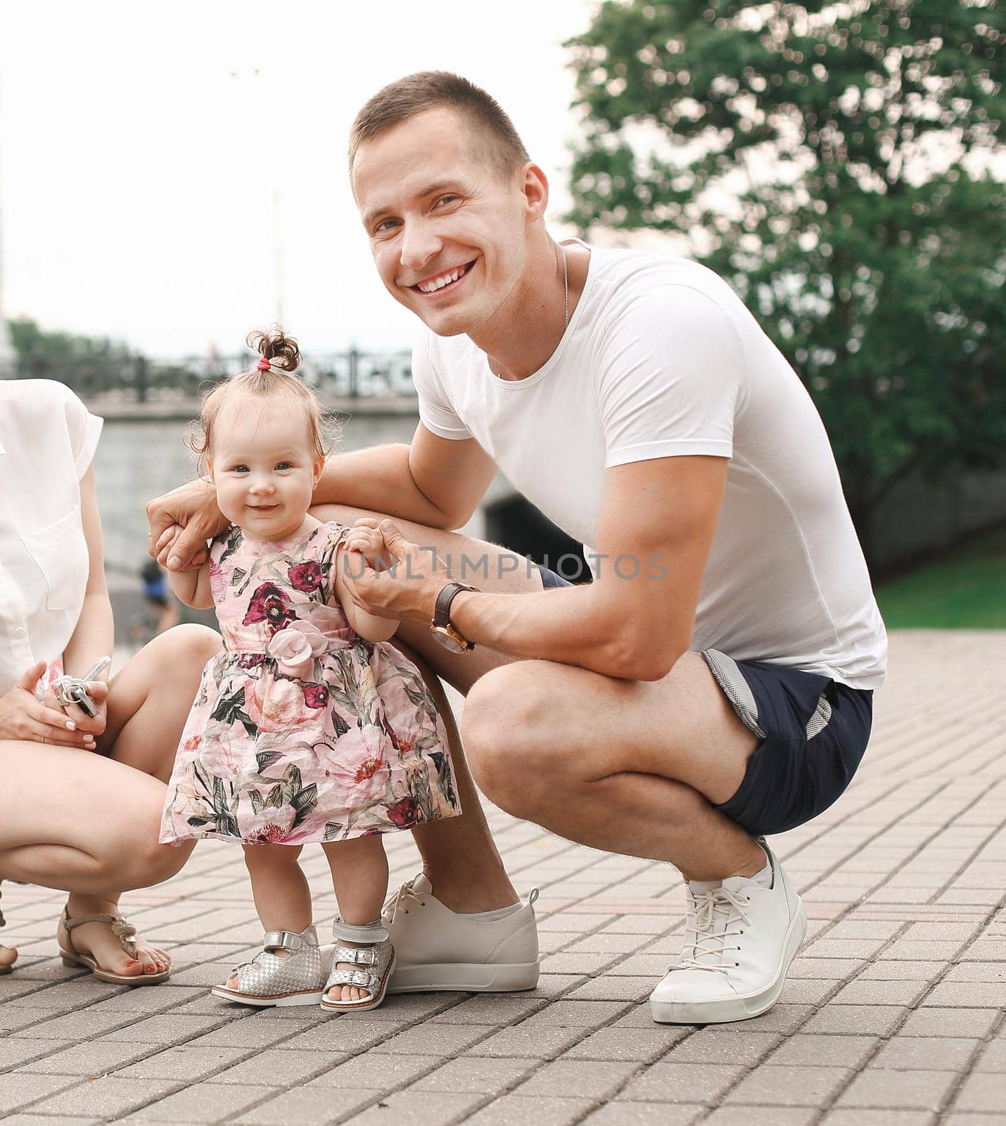 cute little baby girl on walk with parent, first steps.