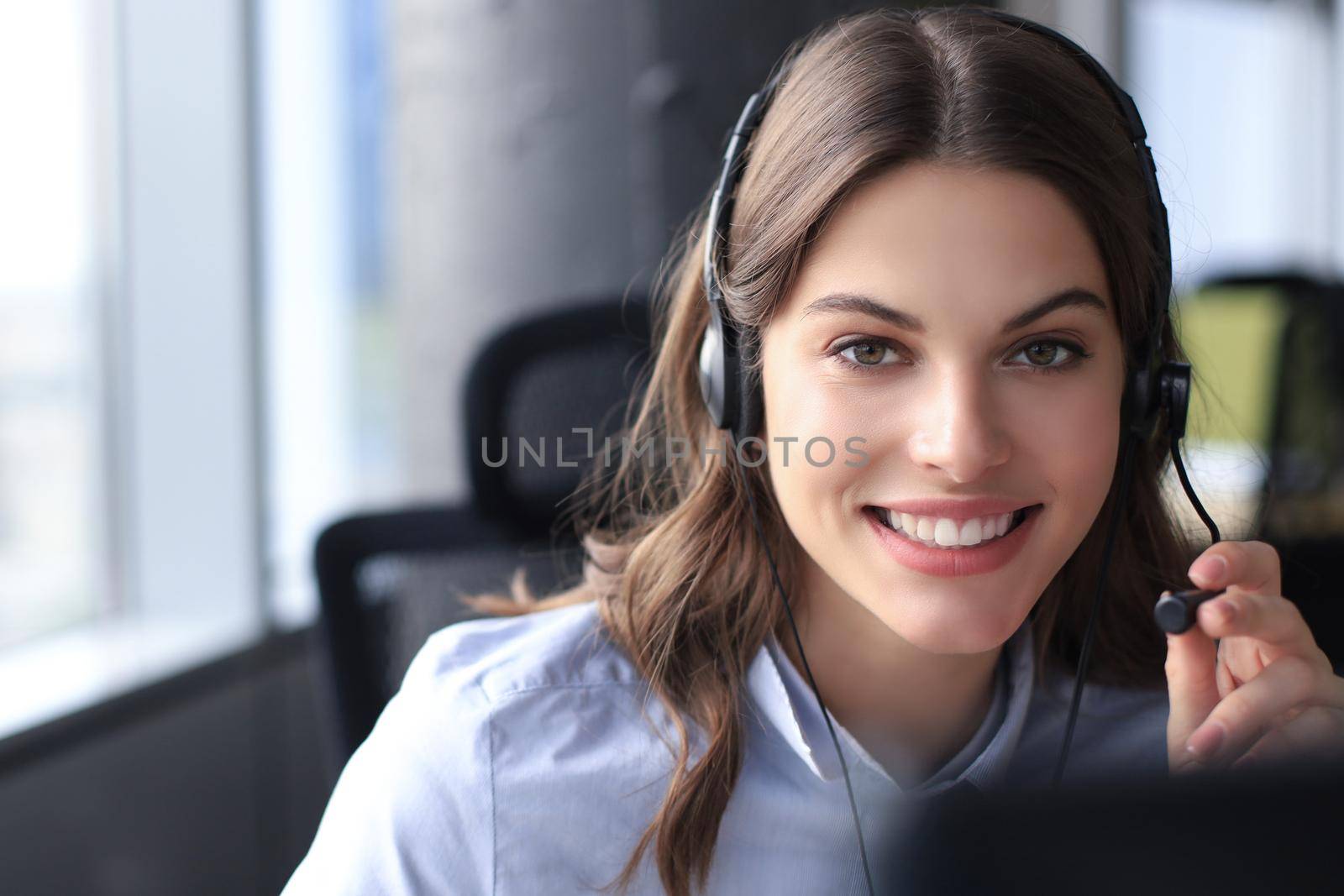 Female customer support operator with headset and smiling