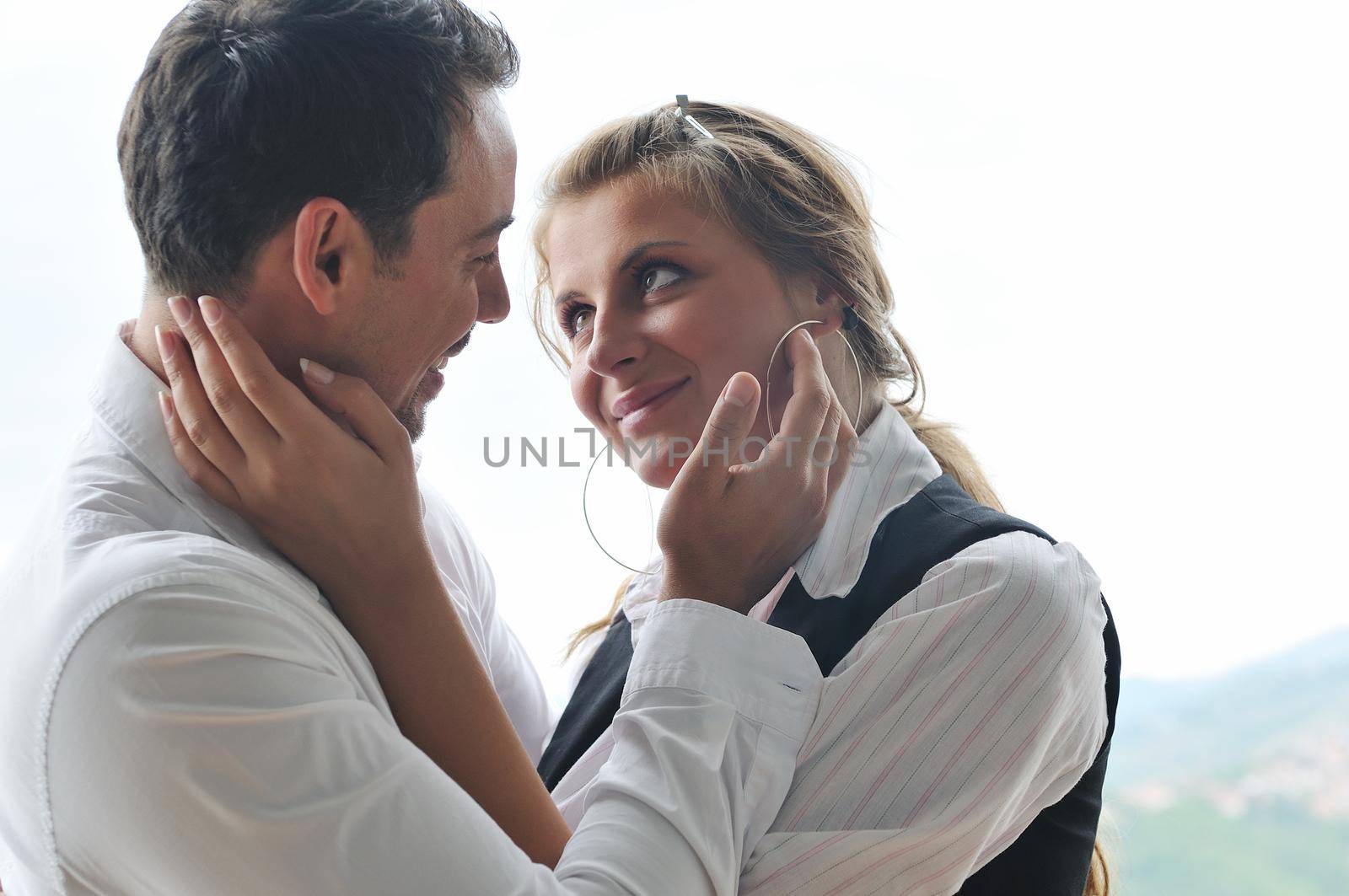 romantic happy couple relax and have fun at balcony in their new home apartment