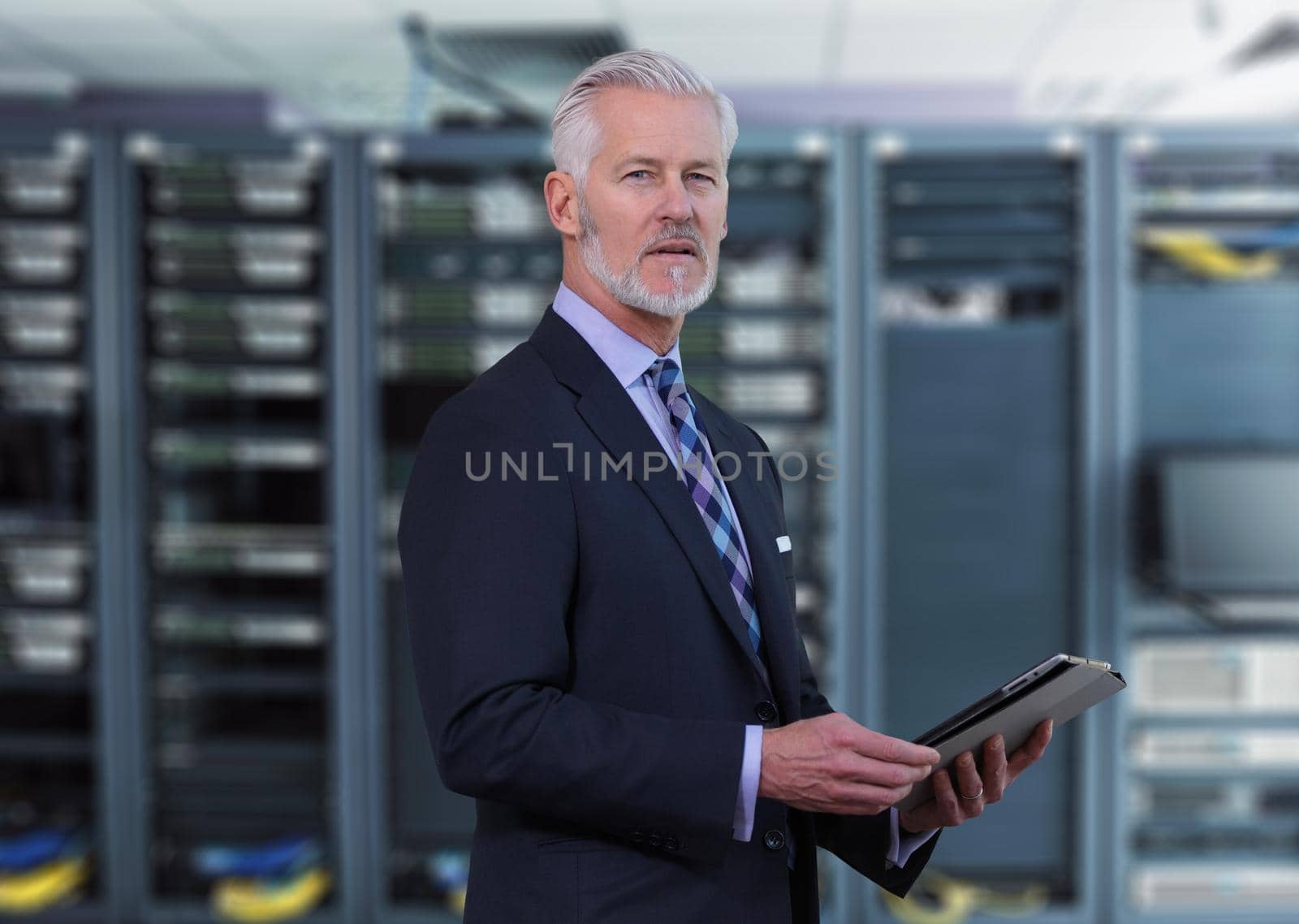 Senior businessman in network server room by dotshock