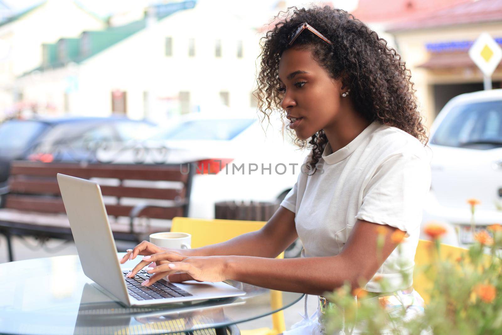 Attractive woman using laptop in cafe. Concept of entrepreneur, businesswoman, freelance worker