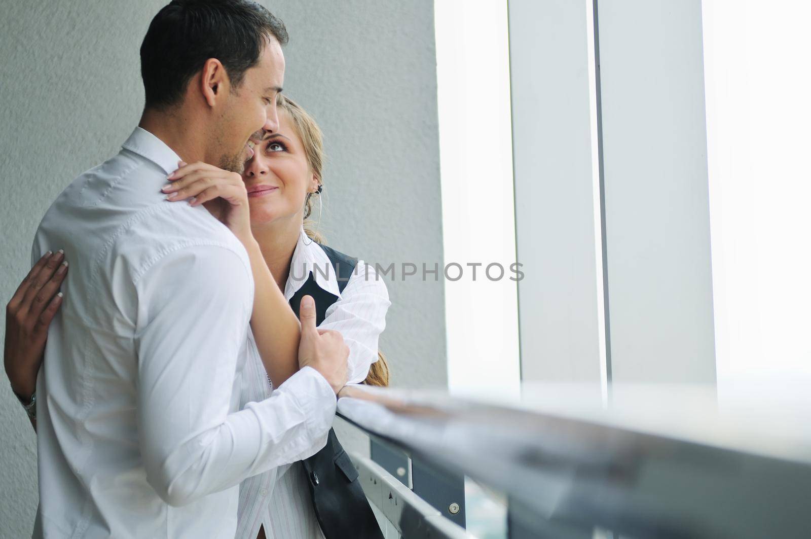 romantic happy couple relax and have fun at balcony in their new home apartment