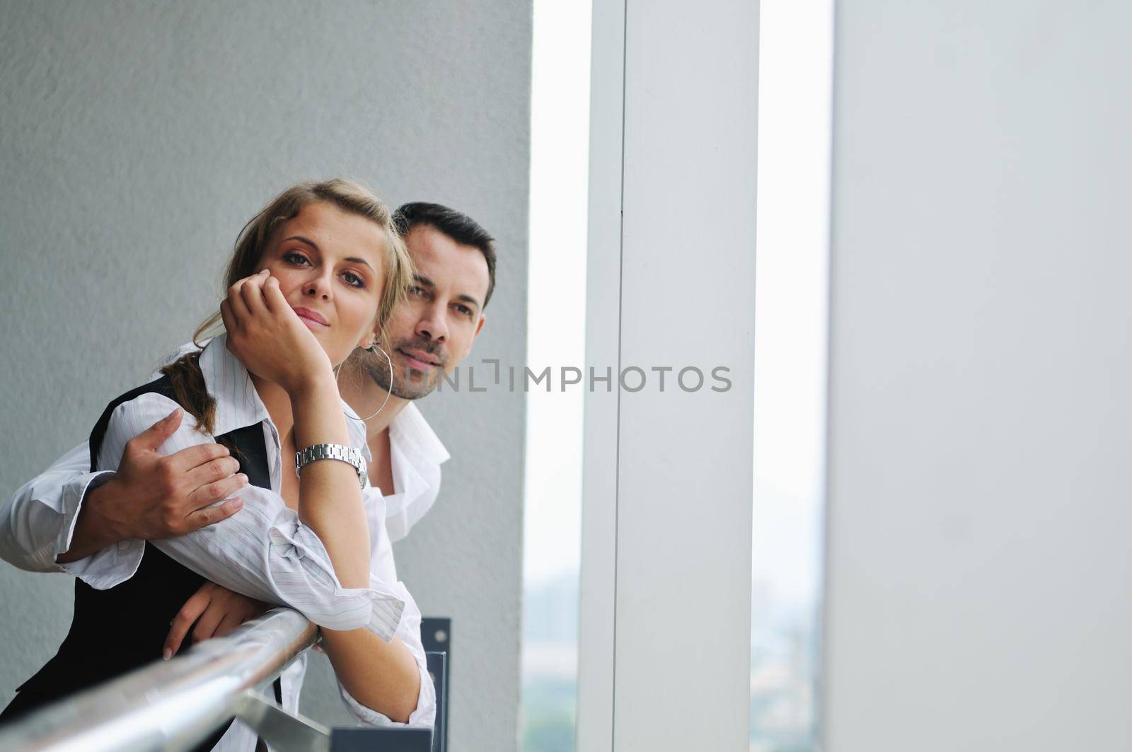 romantic happy couple relax and have fun at balcony in their new home apartment