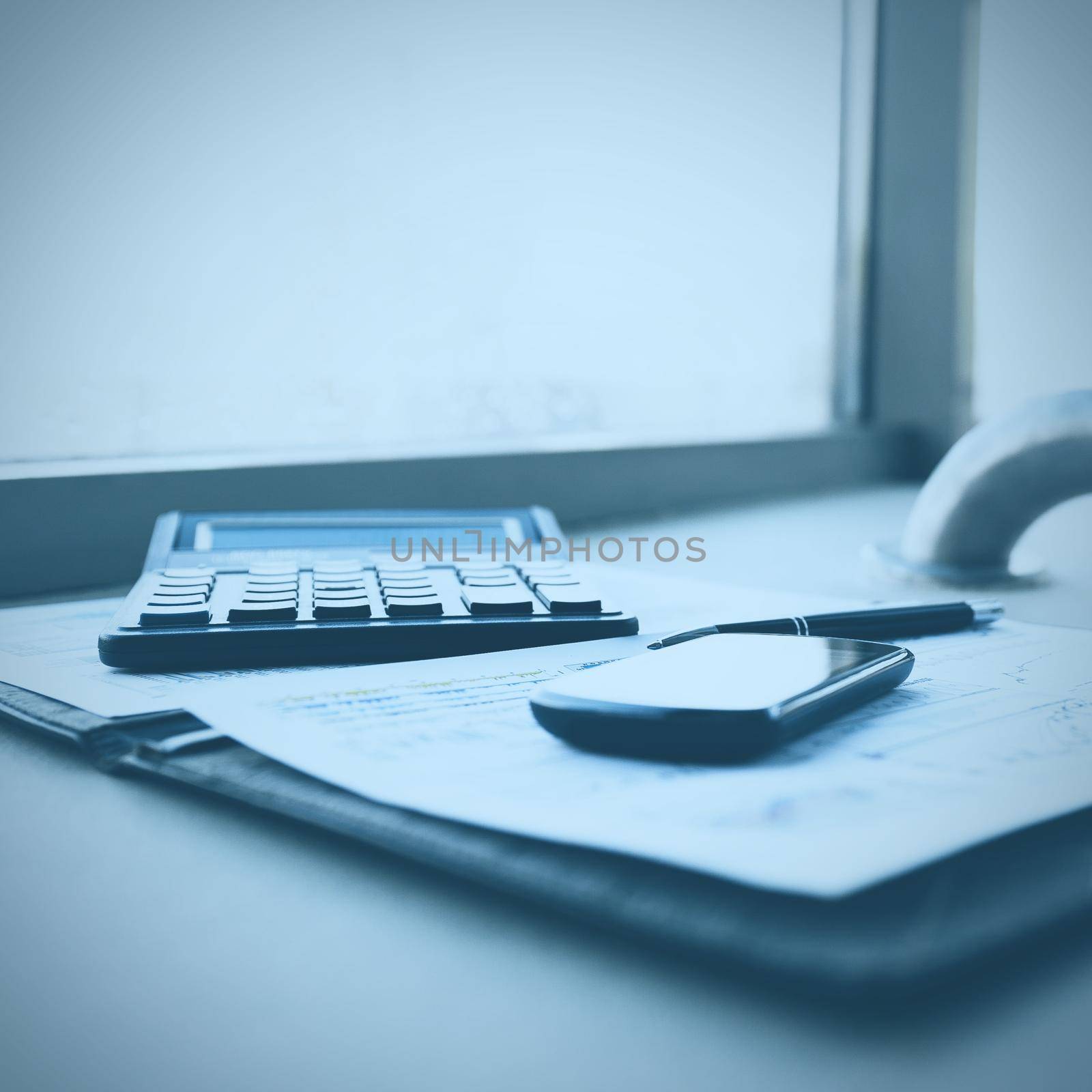 calculator, smartphone and financial documents on the businessman's Desk. business concept