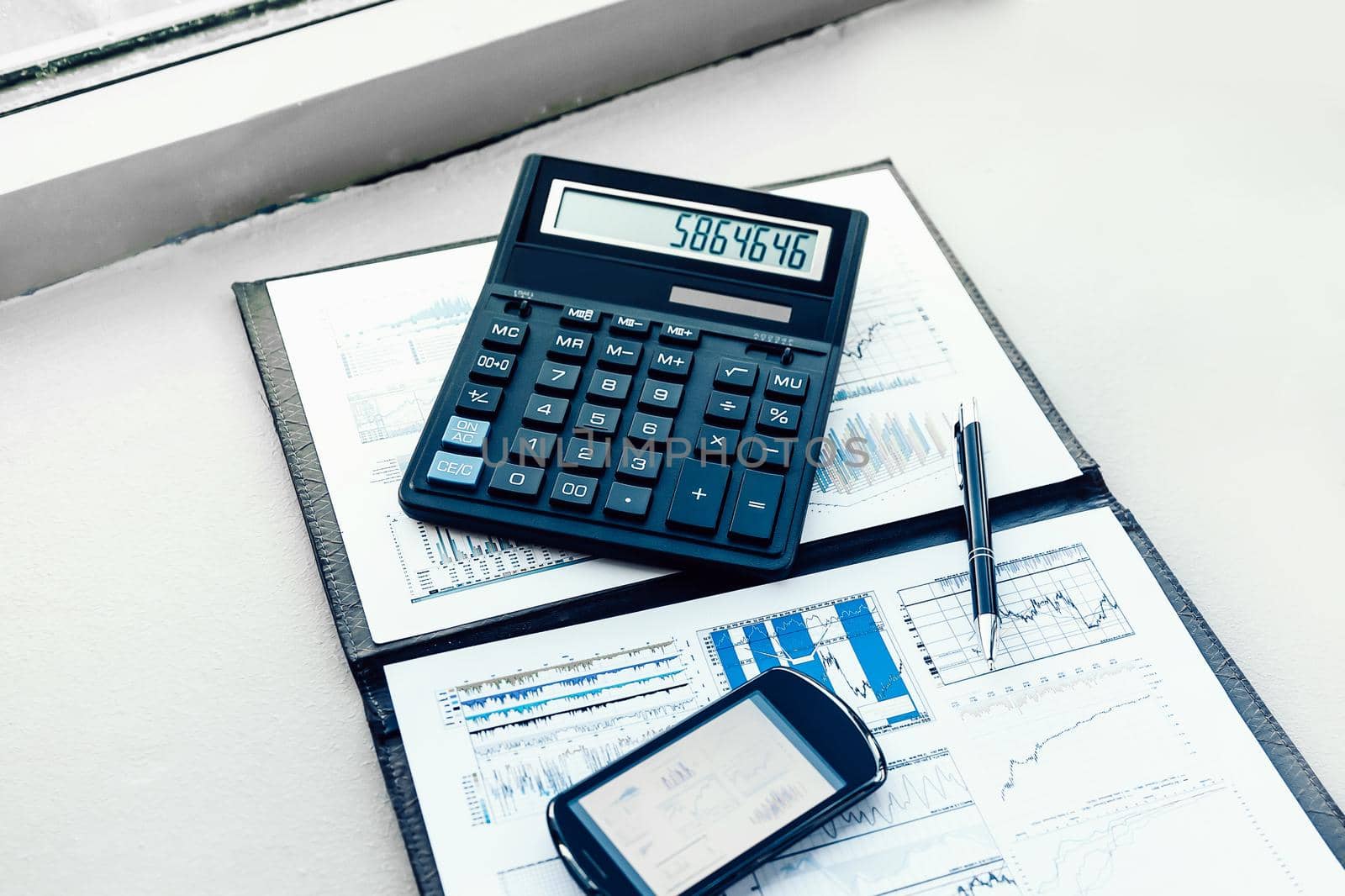 calculator, smartphone and financial documents on the businessman's Desk. business concept