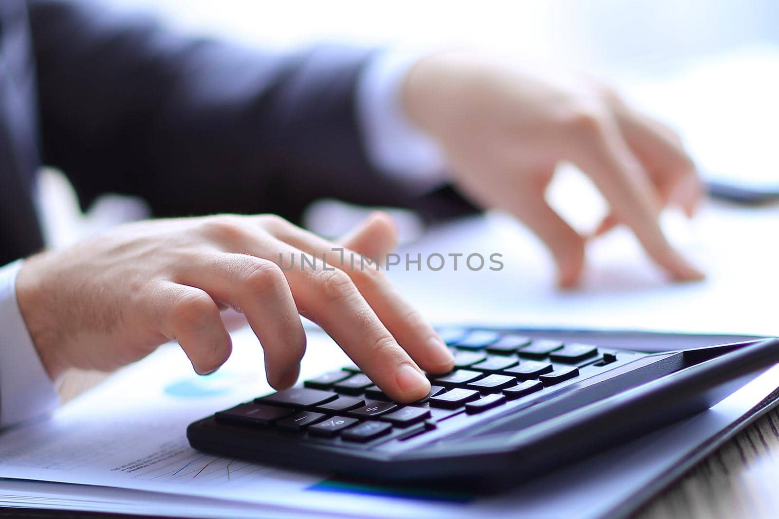 close up. businessman checks the financial data with calculator.