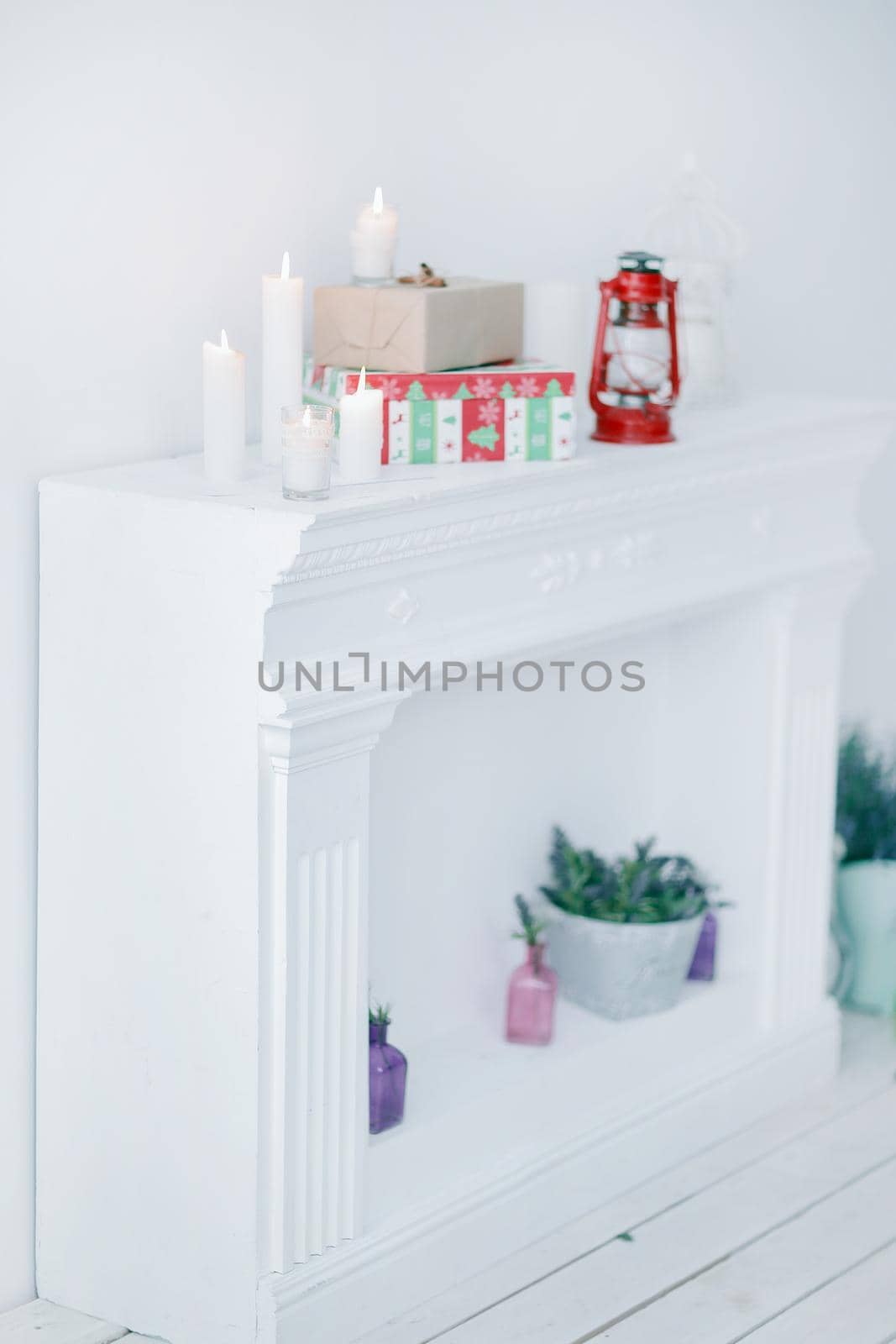 blurred image. candles and gift boxes on the fireplace in the living room .photo with copy space.