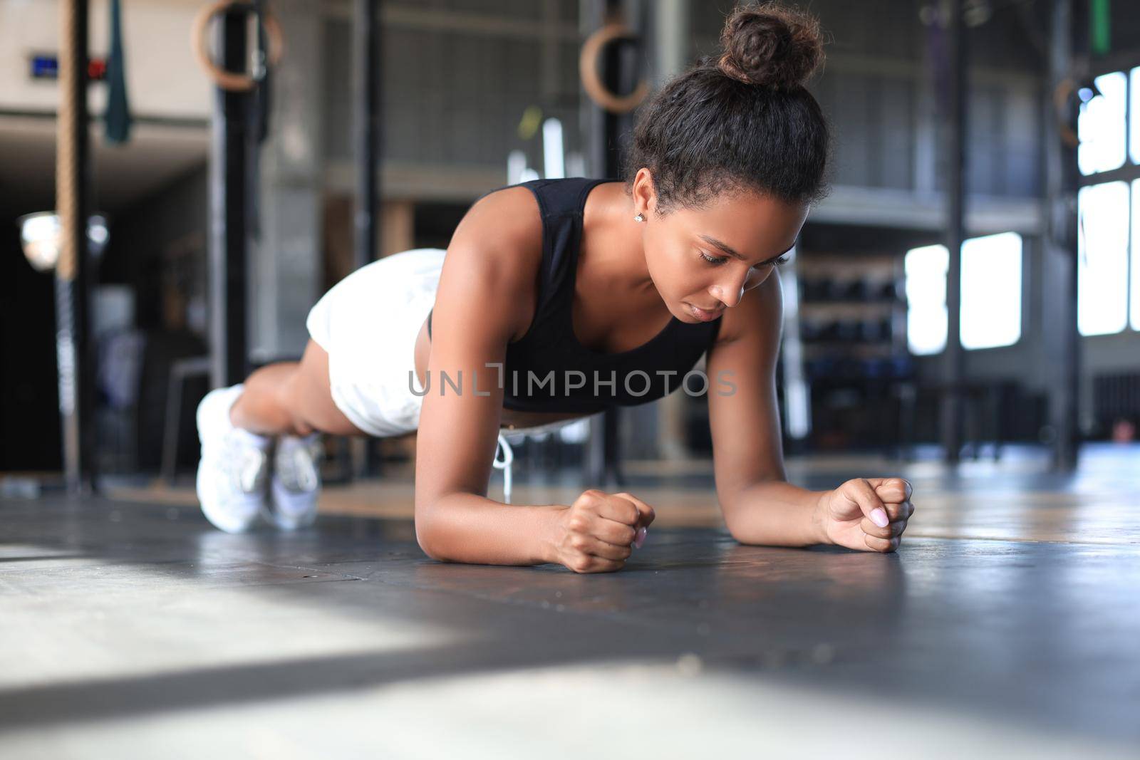 Portrait of a muscular woman on a plank position