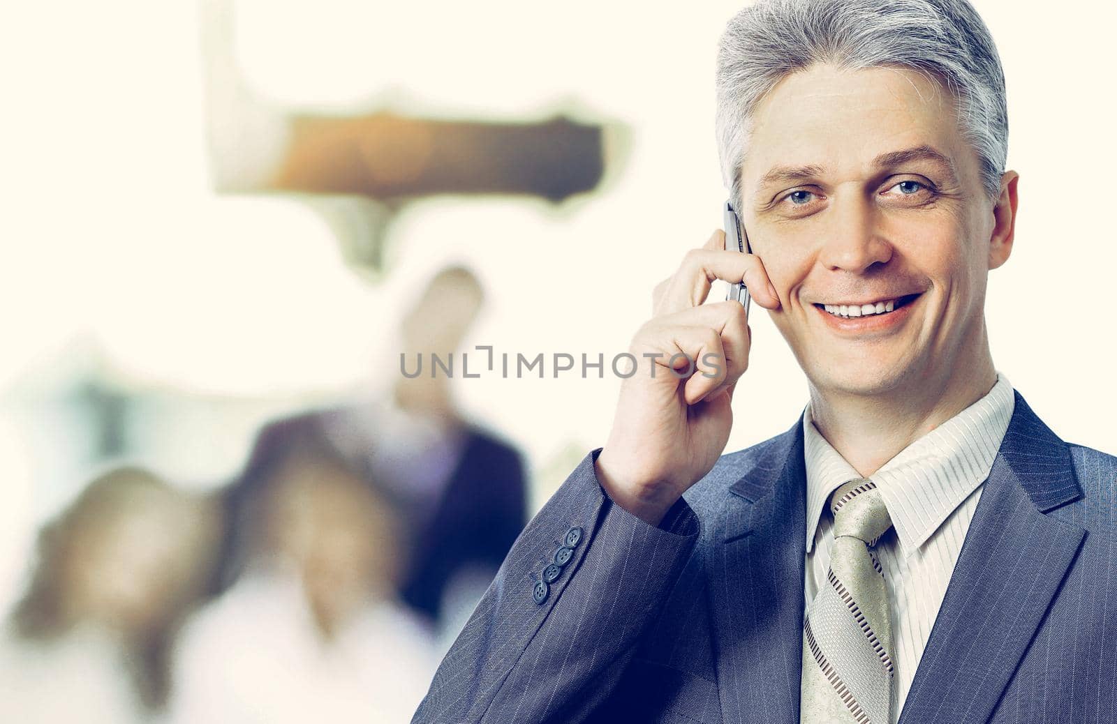 Adult businesswoman talking on the phone makes a deal, team work by SmartPhotoLab