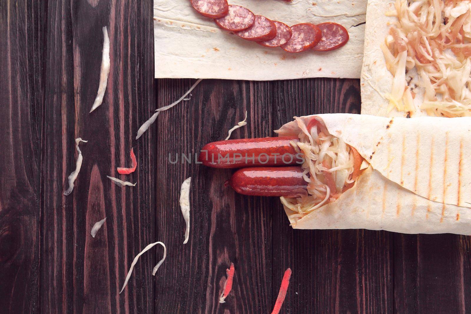 sliced salami and Shawarma on wooden background .photo with copy space.
