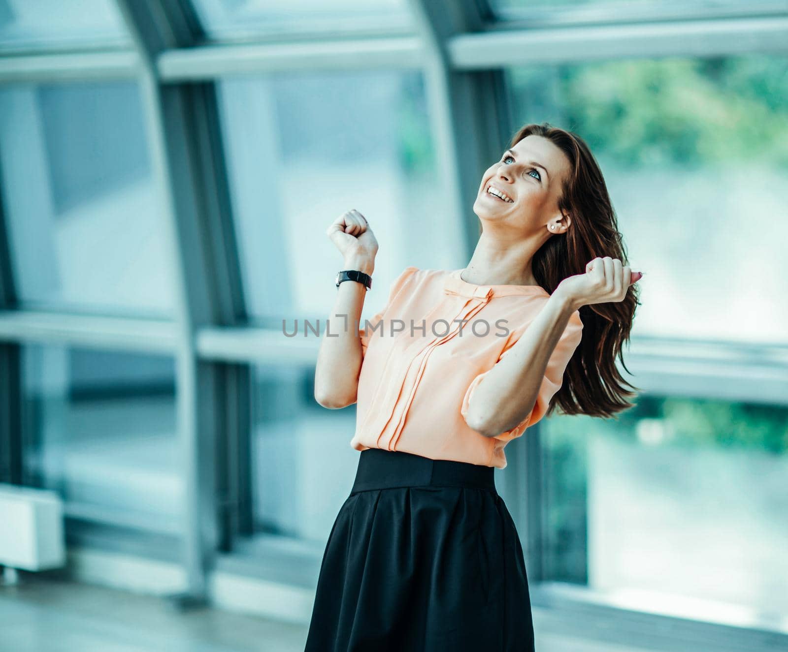 enthusiastic business woman rejoices achievements in business. the photo has a empty space for your text