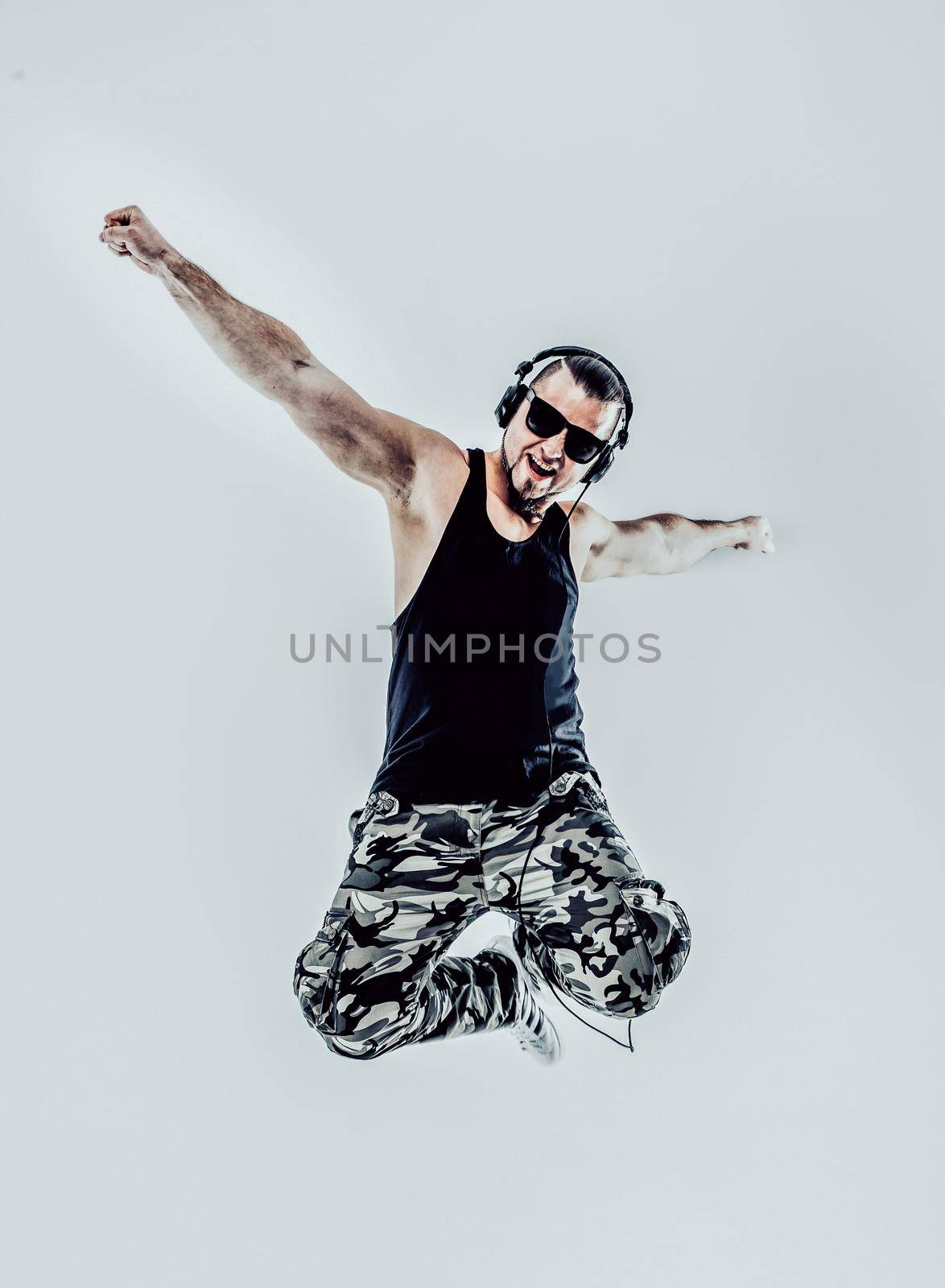 charismatic DJ - rapper with headphones on a white background.the photo has a empty space for your text