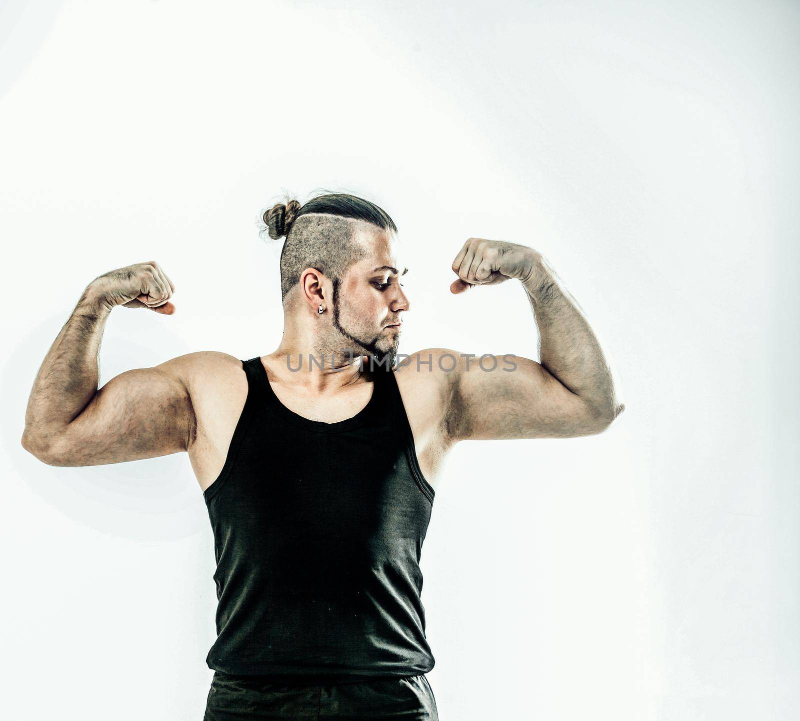 portrait - the trainer on bodybuilding shows an exercise to warm up the muscles. the photo has a empty space for your text