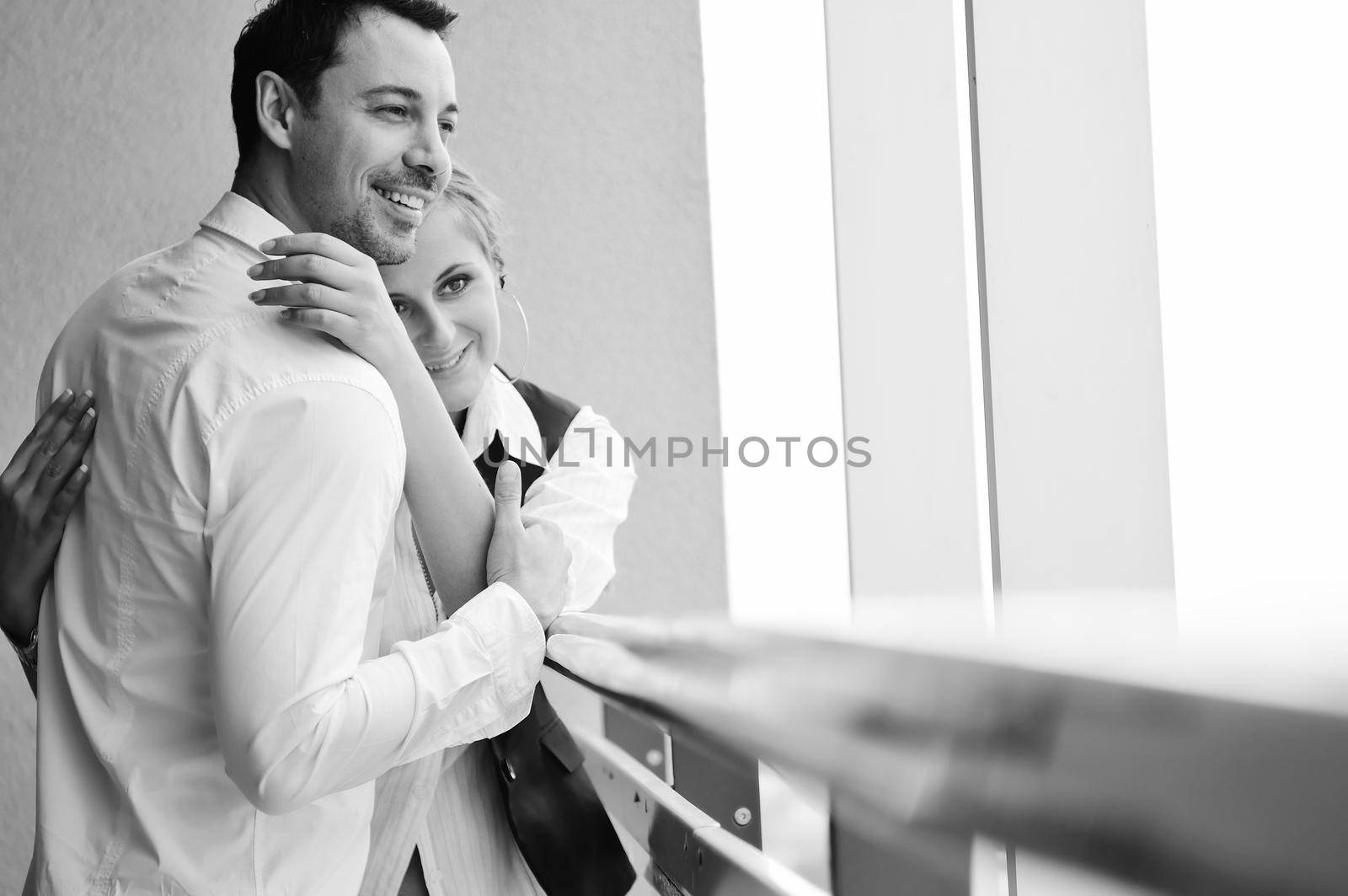 romantic happy couple relax and have fun at balcony in their new home apartment