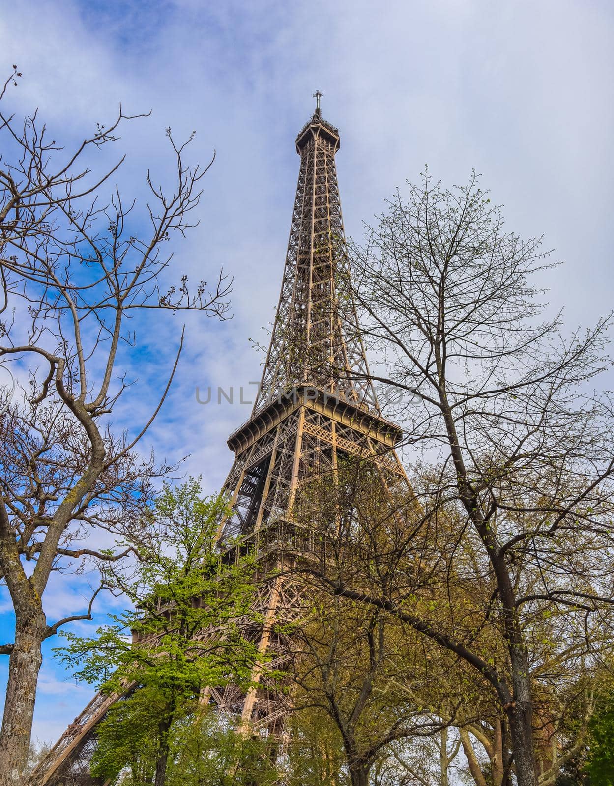 Eiffel Tower in Paris France against blue sky with clouds in spring. April 2019